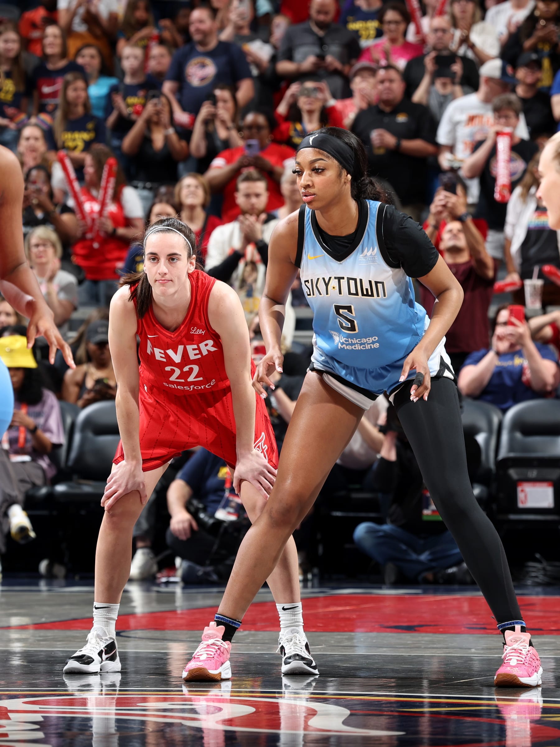 INDIANAPOLIS, IN - JUNE 1: Caitlin Clark #22 of the Indiana Fever and Angel Reese #5 of the Chicago Sky look on during the game on June 1, 2024 at Gainbridge Fieldhouse in Indianapolis, Indiana. NOTE TO USER: User expressly acknowledges and agrees that, by downloading and or using this Photograph, user is consenting to the terms and conditions of the Getty Images License Agreement. Mandatory Copyright Notice: Copyright 2024 NBAE (Photo by Jeff Haynes/NBAE via Getty Images)