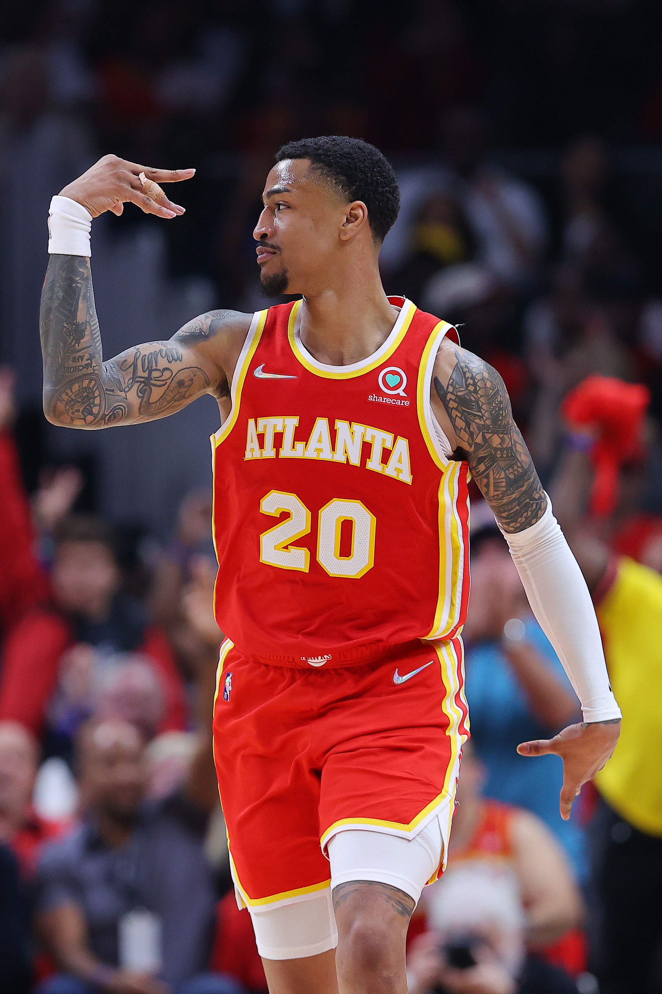 ATLANTA, GEORGIA - APRIL 22: John Collins #20 of the Atlanta Hawks celebrates a three pointer against the Miami Heat during the second quarter in Game Three of the Eastern Conference First Round at State Farm Arena on April 22, 2022 in Atlanta, Georgia. NOTE TO USER: User expressly acknowledges and agrees that, by downloading and or using this photograph, User is consenting to the terms and conditions of the Getty Images License Agreement.  (Photo by Kevin C. Cox/Getty Images)