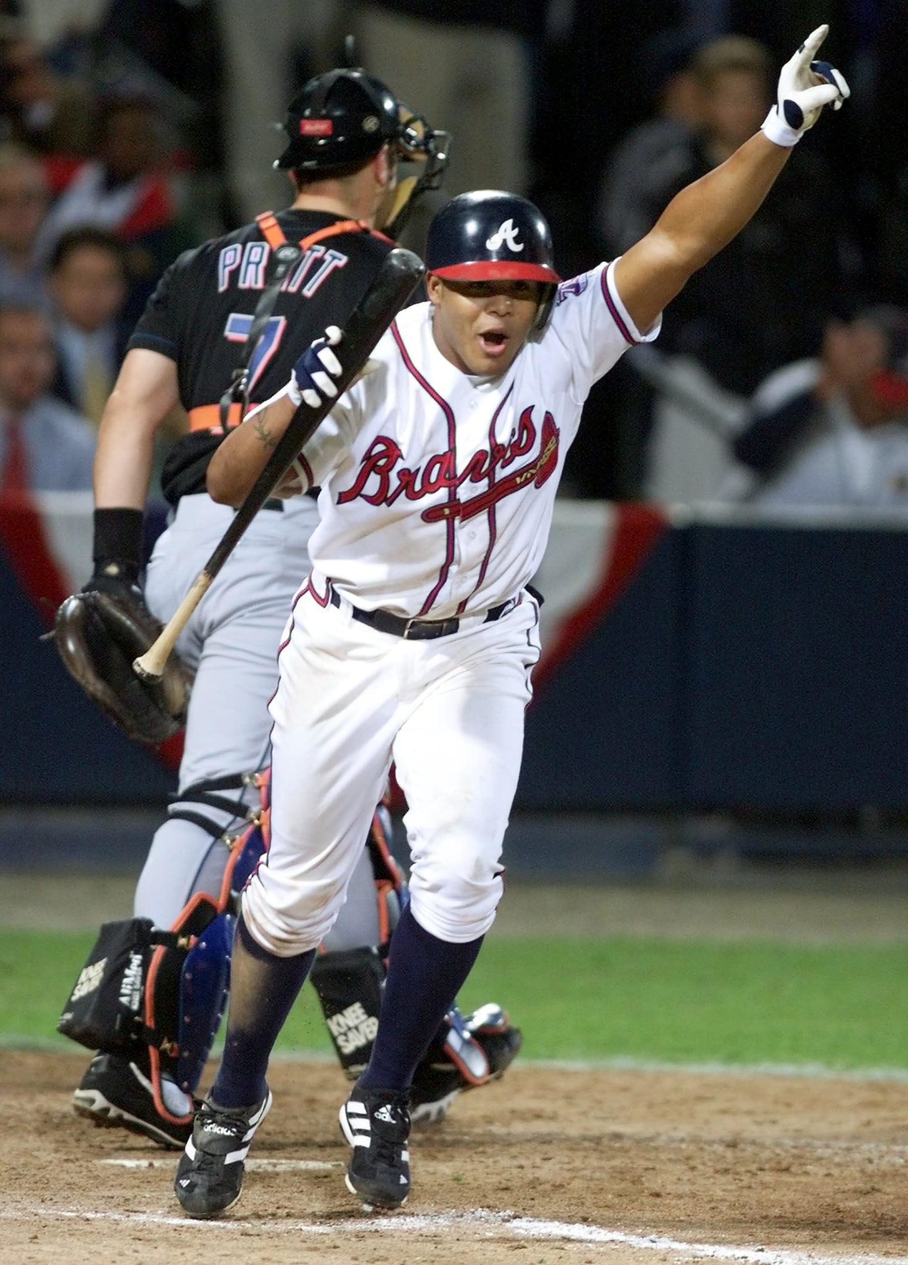 ATLANTA, UNITED STATES:  Andruw Jones (R) of the Atlanta Braves celebrates after taking a walk in the 11th inning against the New York Mets as Mets catcher Todd Pratt (L) walks back to the bench 19 October, 1999 during game six of the National League Championship Series at Turner Field in Atlanta, GA. The Brave won the game 10-9 to win the best-of-seven game series 4-2.  (ELECTRONIC IMAGE)  AFP PHOTO/Jeff HAYNES (Photo credit should read JEFF HAYNES/AFP via Getty Images)