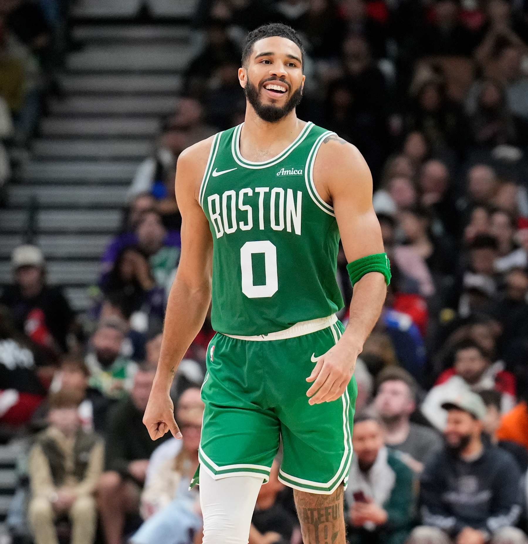 TORONTO, ON - OCTOBER 15: Jayson Tatum #0 of the Boston Celtics smiles in a break in play against the Toronto Raptors during the second half of their preseason basketball game at the Scotiabank Arena on October 15, 2024 in Toronto, Ontario, Canada. NOTE TO USER: User expressly acknowledges and agrees that, by downloading and/or using this Photograph, user is consenting to the terms and conditions of the Getty Images License Agreement. (Photo by Mark Blinch/Getty Images)
