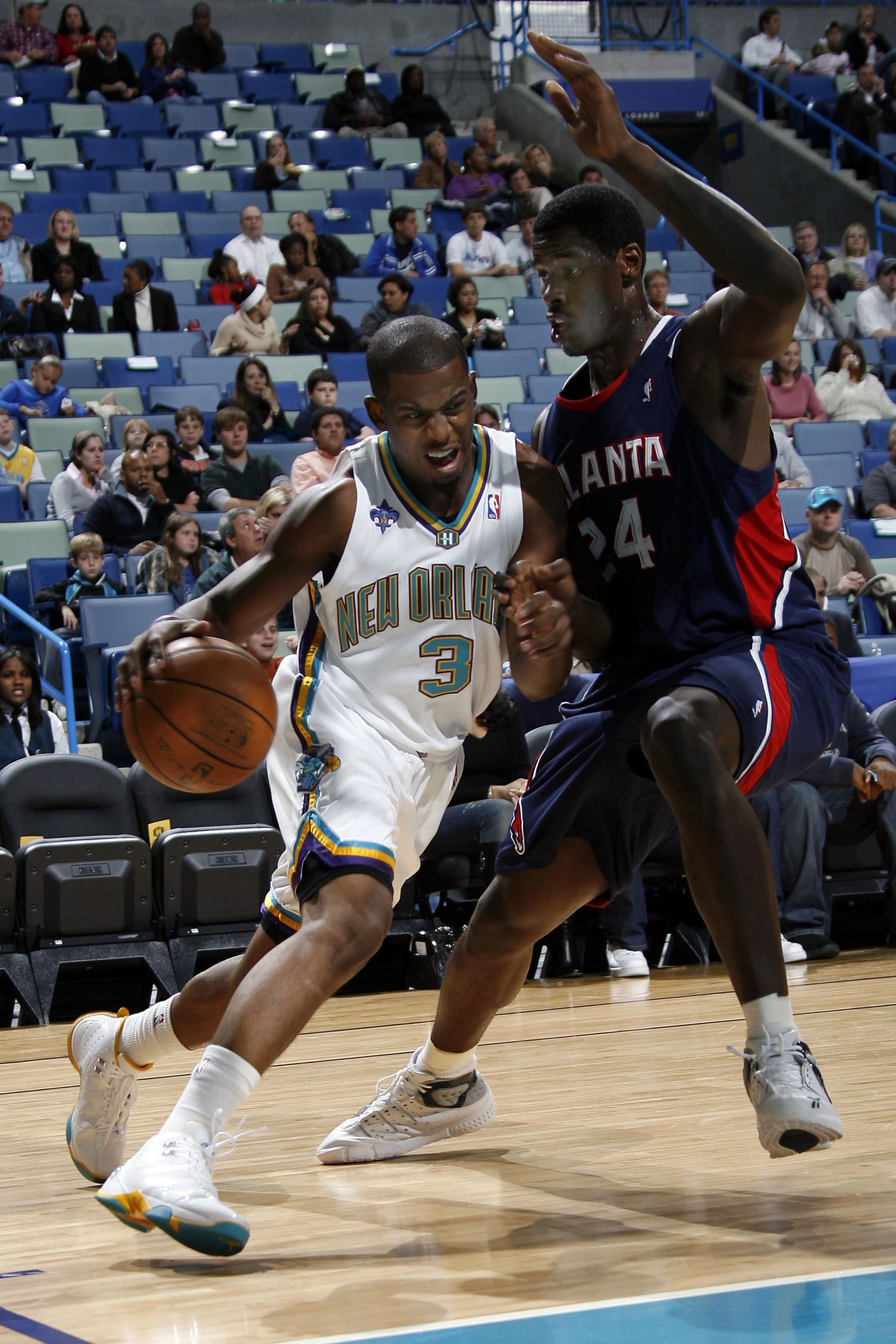 NEW ORLEANS - OCTOBER 24:  Chris Paul #3 of the New Orleans Hornets drives past Marvin Williams #24 of the Atlanta Hawks during an NBA preseason game October 24, 2007 at the New Orleans Arena in New Orleans, Louisiana. NOTE TO USER: User expressly acknowledges and agrees that, by downloading and or using this Photograph, user is consenting to the terms and conditions of the Getty Images License Agreement. Mandatory Copyright Notice: Copyright 2007 NBAE (Photo by Layne Murdoch/NBAE via Getty Images)