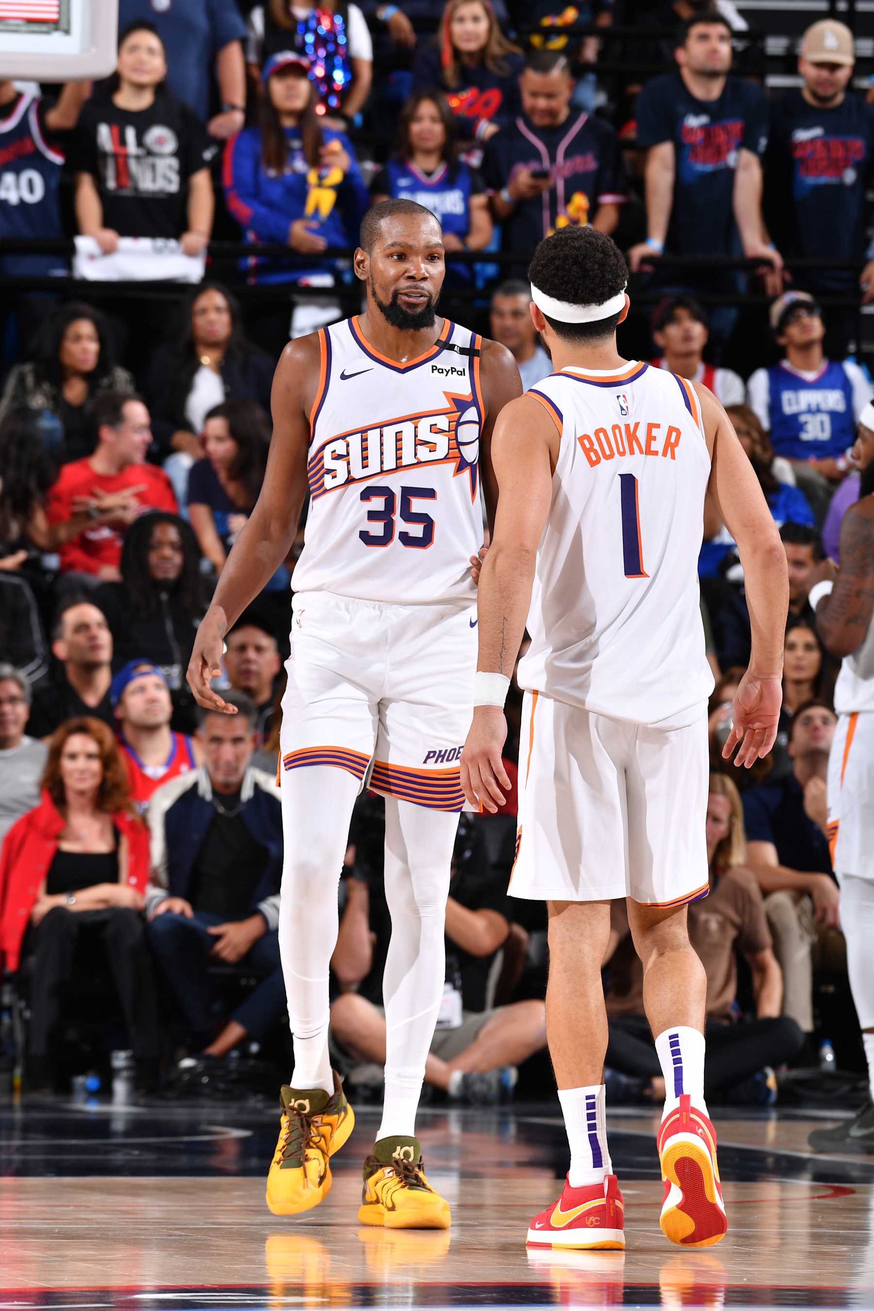 INGLEWOOD, CA - OCTOBER 23: Kevin Durant #35 and Devin Booker #1 of the Phoenix Suns talk during the game against the LA Clippers on October 23, 2024 at Intuit Dome in Los Angeles, California. NOTE TO USER: User expressly acknowledges and agrees that, by downloading and/or using this Photograph, user is consenting to the terms and conditions of the Getty Images License Agreement. Mandatory Copyright Notice: Copyright 2024 NBAE (Photo by Juan Ocampo/NBAE via Getty Images)