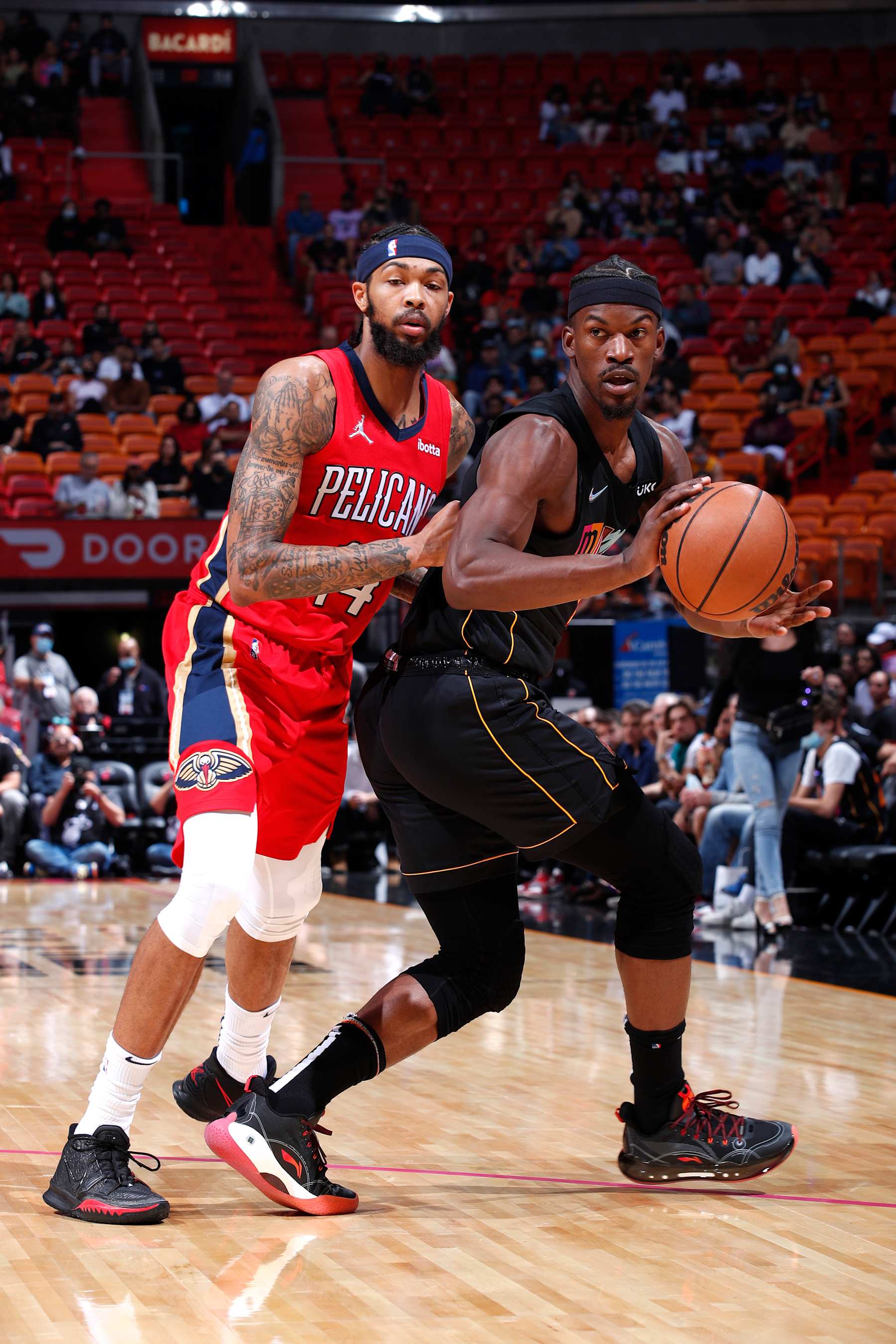 MIAMI, FL - NOVEMBER 17:  Jimmy Butler #22 of the Miami Heat moves the ball against Brandon Ingram #14 of the New Orleans Pelicans  during the game against New Orleans Pelicans on November 17, 2021 at American Airlines Arena in Miami, Florida. NOTE TO USER: User expressly acknowledges and agrees that, by downloading and or using this Photograph, user is consenting to the terms and conditions of the Getty Images License Agreement. Mandatory Copyright Notice: Copyright 2021 NBAE (Photo by Jeff Haynes/NBAE via Getty Images)