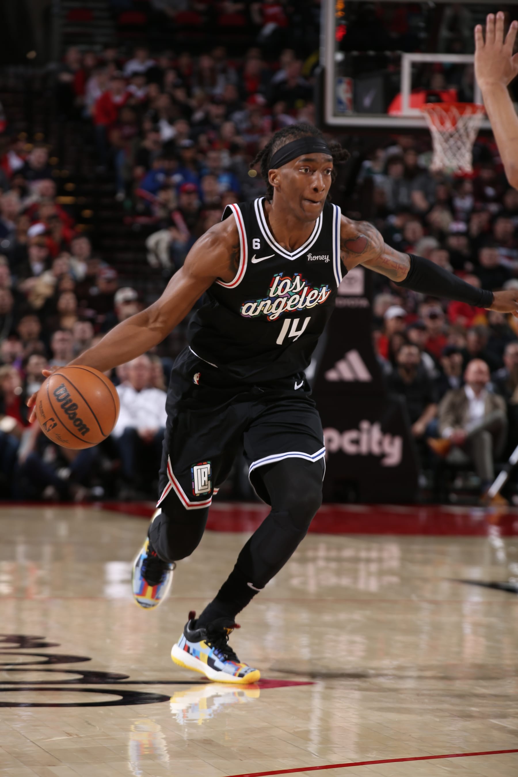 PORTLAND, OR - MARCH 19: Terance Mann #14 of the LA Clippers moves the ball during the game against the Portland Trail Blazers on March 19, 2023 at the Moda Center Arena in Portland, Oregon. NOTE TO USER: User expressly acknowledges and agrees that, by downloading and or using this photograph, user is consenting to the terms and conditions of the Getty Images License Agreement. Mandatory Copyright Notice: Copyright 2023 NBAE (Photo by Cameron Browne/NBAE via Getty Images)