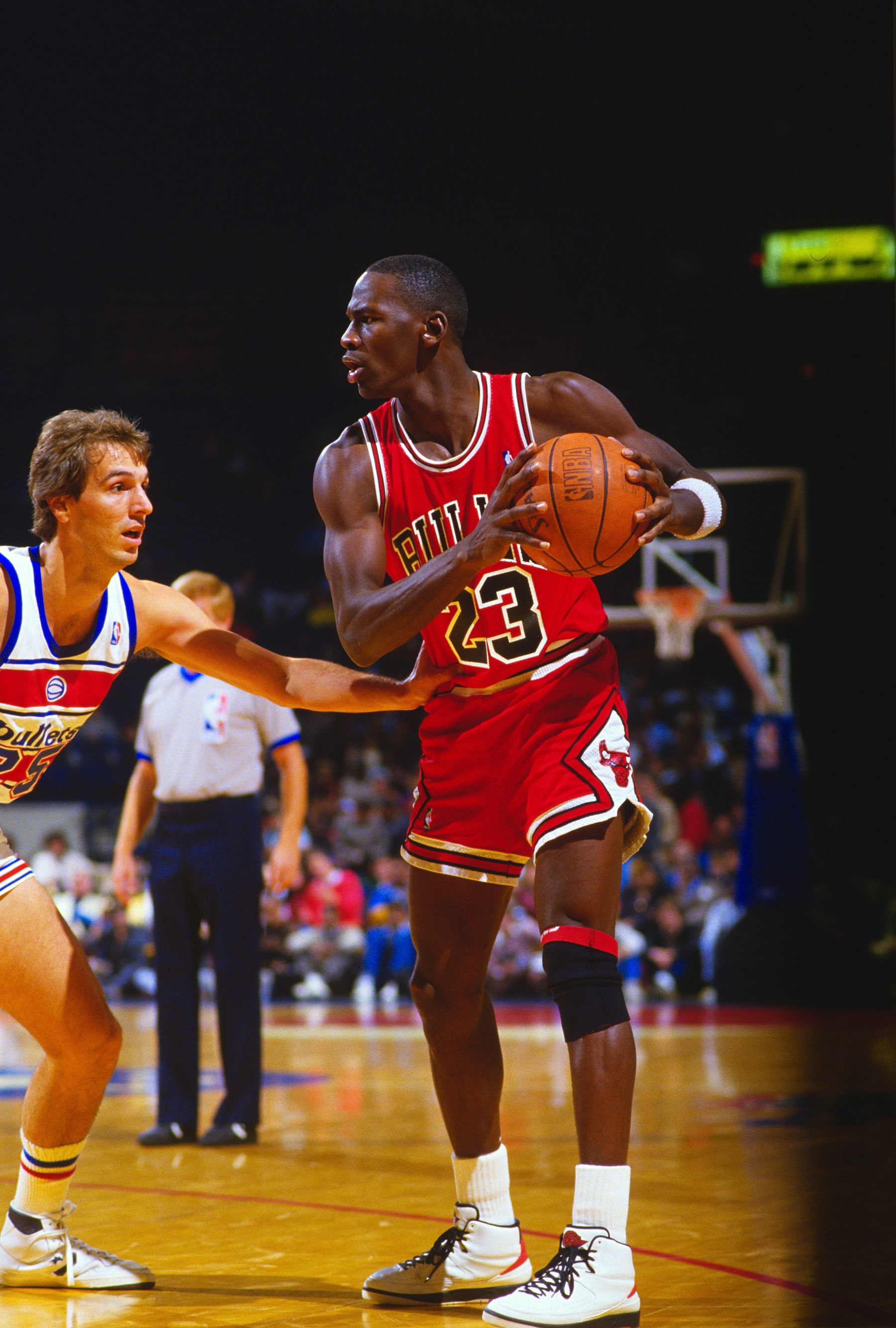 LANDOVER, MD - CIRCA 1986: Michael Jordan #23 of the Chicago Bulls holding on to the ball is guarded by Mike O'Koren #25 of the Washington Bullets during an NBA basketball game circa 1986 at the Capital Centre in Landover, Maryland. Jordan played for the Bulls from 1984-93 and 1995 - 98. (Photo by Focus on Sport/Getty Images) 