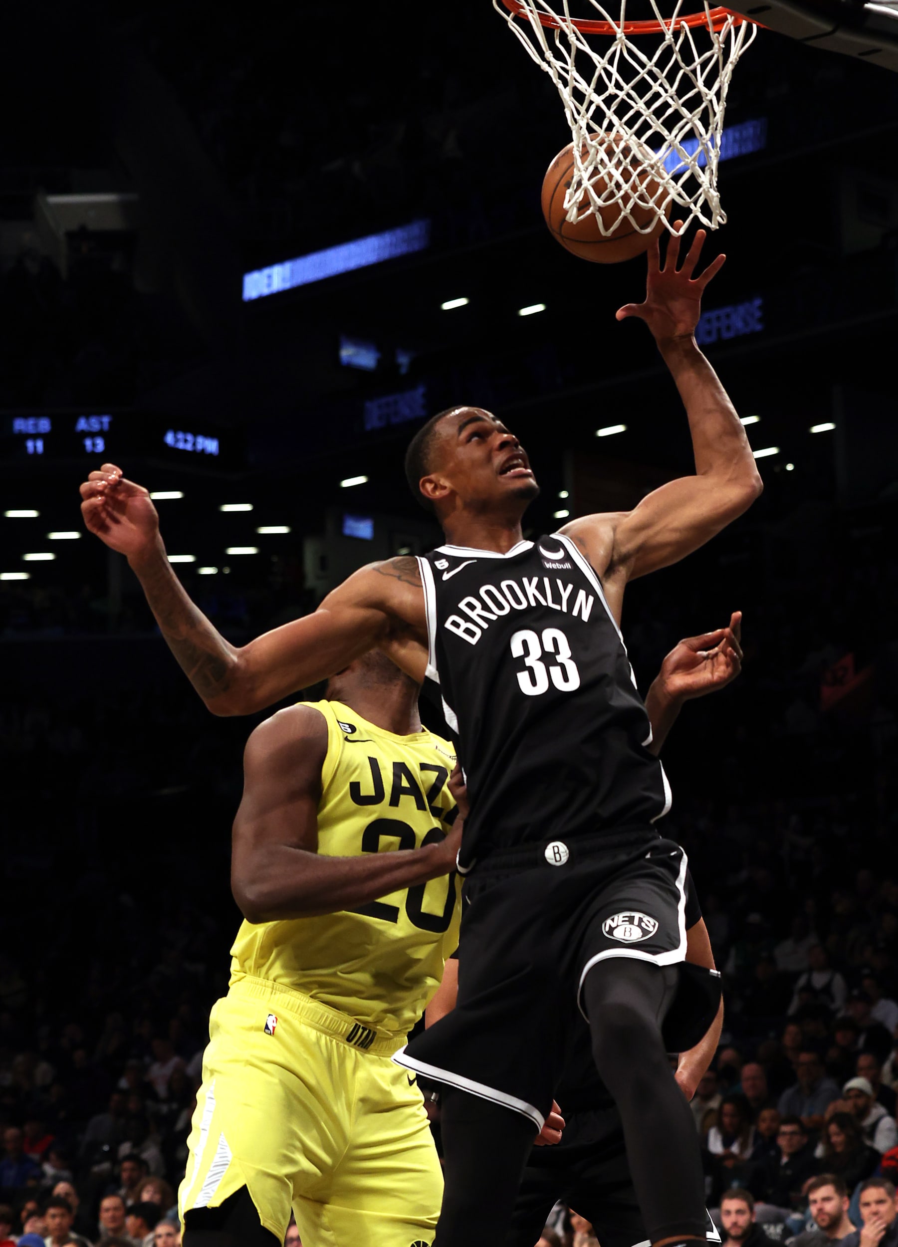 NEW YORK, NEW YORK - APRIL 02:  Nic Claxton #33 of the Brooklyn Nets and Udoka Azubuike #20 of the Utah Jazz compete for a rebound during the game at Barclays Center on April 02, 2023 in New York City. (Photo by Jamie Squire/Getty Images)