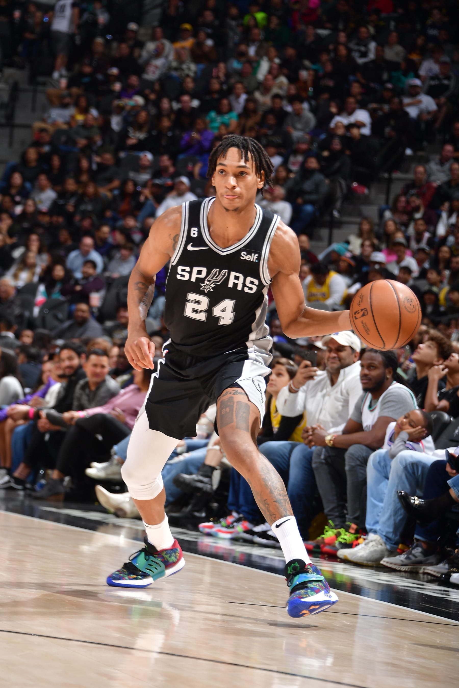 SAN ANTONIO, TX - NOVEMBER 26: Devin Vassell #24 of the San Antonio Spurs passes the ball during the game against the Los Angeles Lakers on November 26, 2022 at the AT&T Center in San Antonio, Texas. NOTE TO USER: User expressly acknowledges and agrees that, by downloading and or using this photograph, user is consenting to the terms and conditions of the Getty Images License Agreement. Mandatory Copyright Notice: Copyright 2022 NBAE (Photos by Michael Gonzales/NBAE via Getty Images)