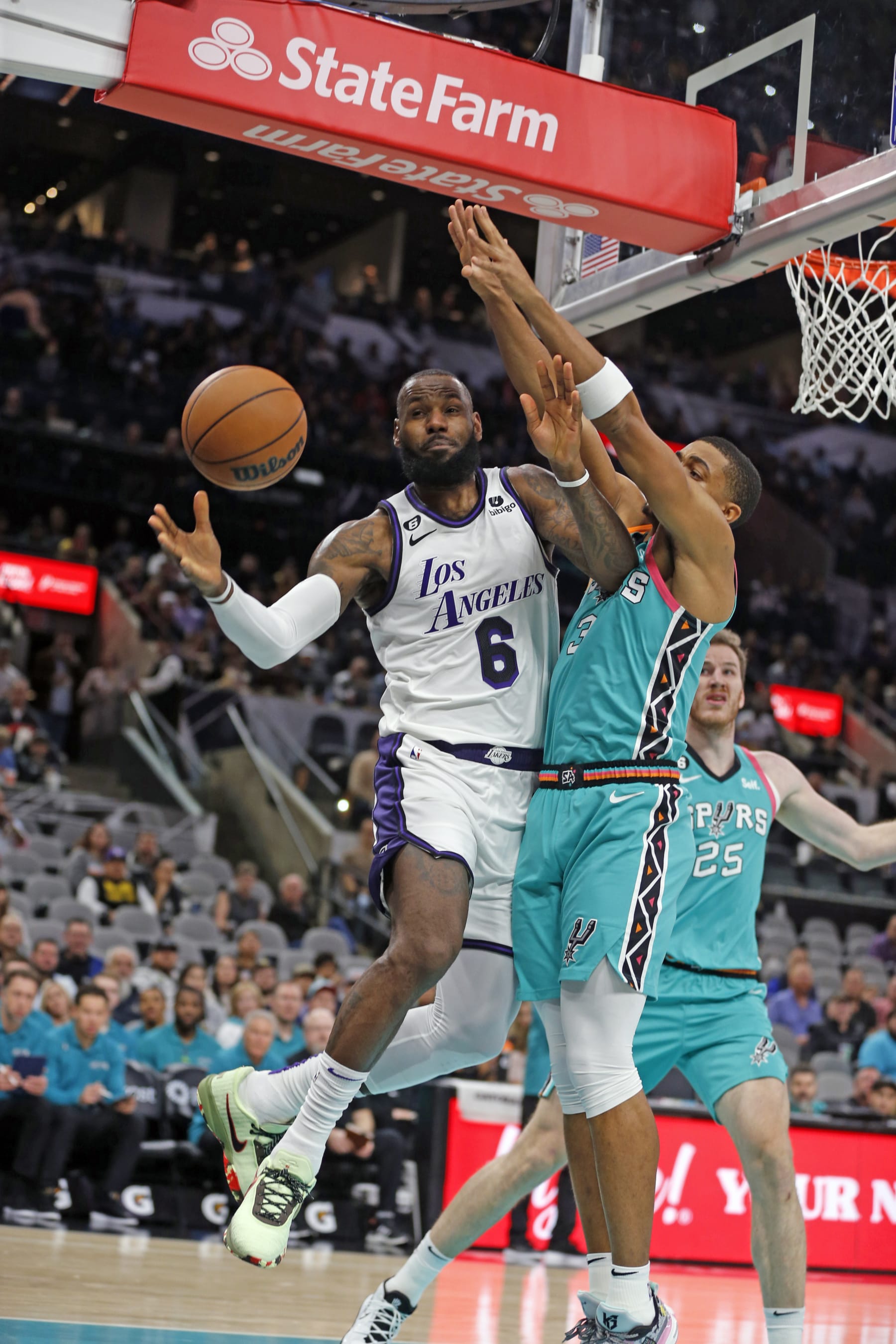 SAN ANTONIO, TX - NOVEMBER 25: LeBron James #6 of the Los Angeles Lakers drives by Keldon Johnson #3 of the San Antonio Spurs in the first half at AT&T Center on November 25, 2022 in San Antonio, Texas. NOTE TO USER: User expressly acknowledges and agrees that, by downloading and or using this photograph, User is consenting to terms and conditions of the Getty Images License Agreement. (Photo by Ronald Cortes/Getty Images)