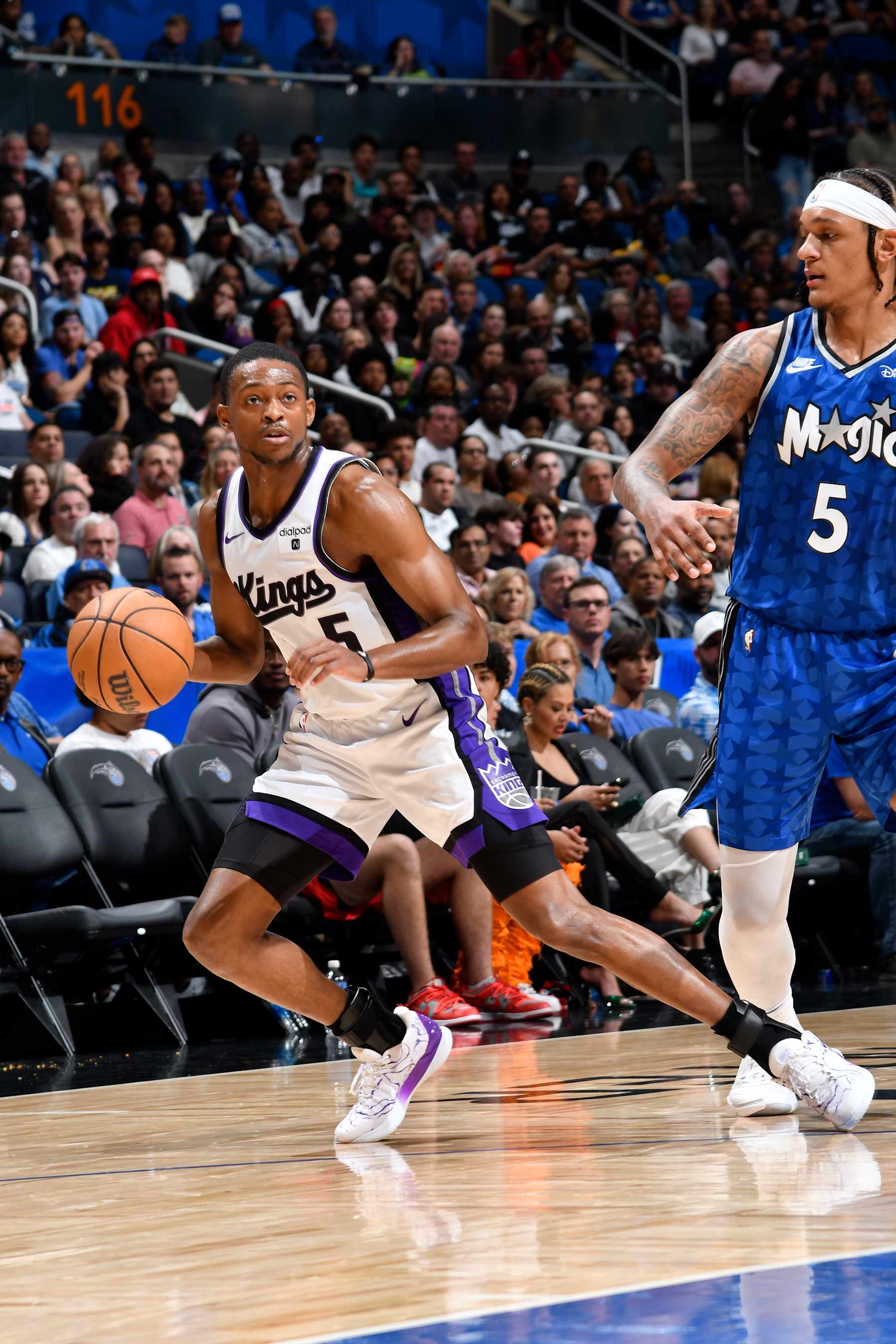 ORLANDO, FL - MARCH 23: De'Aaron Fox #5 of the Sacramento Kings handles the ball against Paolo Banchero #5 of the Orlando Magic during the game on March 23, 2024 at the Kia Center in Orlando, Florida. NOTE TO USER: User expressly acknowledges and agrees that, by downloading and or using this photograph, User is consenting to the terms and conditions of the Getty Images License Agreement. Mandatory Copyright Notice: Copyright 2024 NBAE (Photo by Fernando Medina/NBAE via Getty Images)
