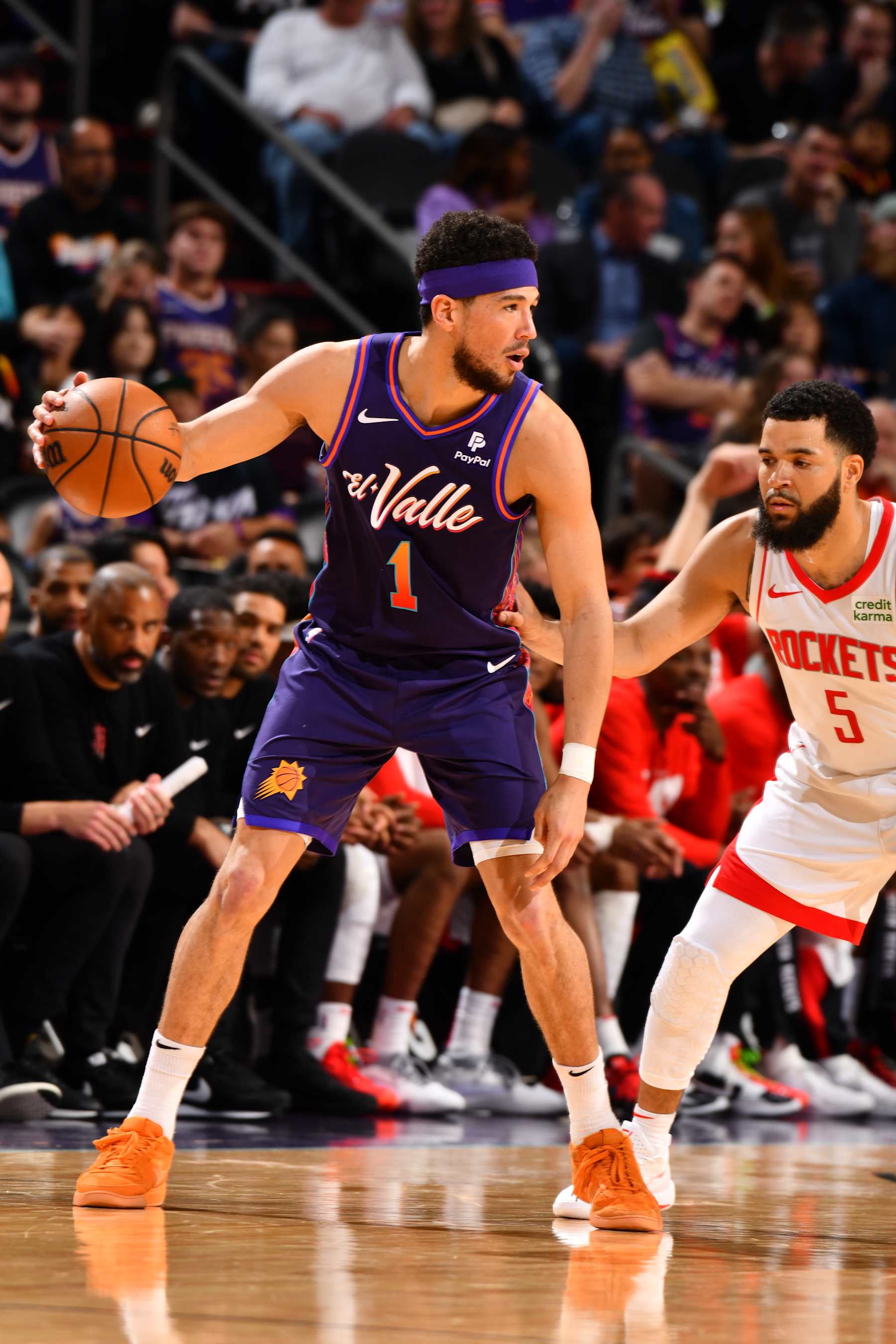 PHOENIX, AZ - FEBRUARY 29: Devin Booker #1 of the Phoenix Suns handles the ball against Fred VanVleet #5 of the Houston Rockets during the game on February 29, 2024 at Footprint Center in Phoenix, Arizona. NOTE TO USER: User expressly acknowledges and agrees that, by downloading and or using this photograph, user is consenting to the terms and conditions of the Getty Images License Agreement. Mandatory Copyright Notice: Copyright 2024 NBAE (Photo by Barry Gossage/NBAE via Getty Images)
