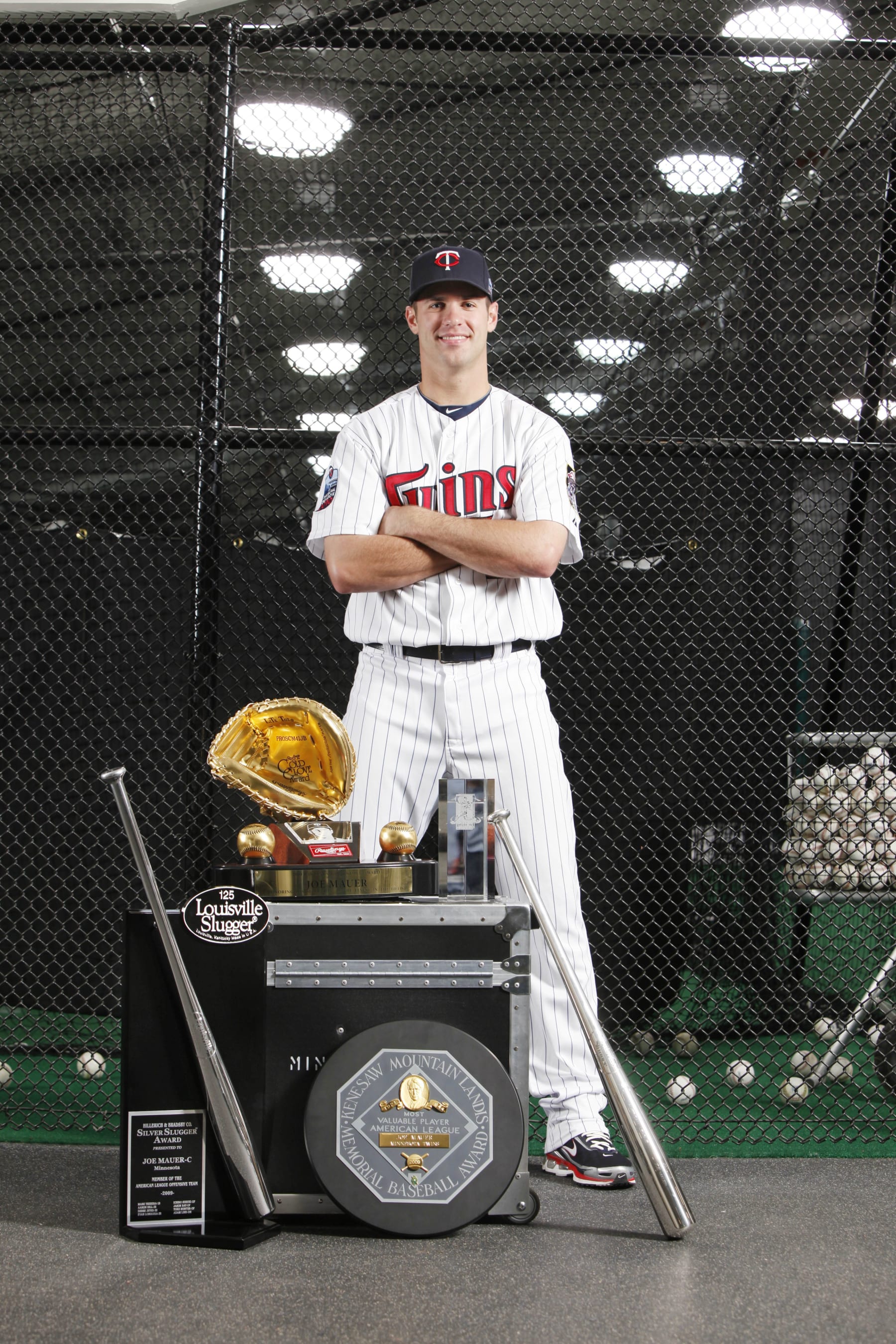 MINNEAPOLIS, MN - APRIL 21: Joe Mauer #7 of the Minnesota Twins poses with his 2009 AL MVP Award, 2009 Silver Slugger Award, 2009 AL Batting Champion Award, 2009 MLB Players' Choice Award, and 2009 Golden Glove Award near the batting cages prior to the game with the Cleveland Indians on April 21, 2010 at Target Field in Minneapolis, Minnesota.  The Twins won 6-0.  (Photo by Bruce Kluckhohn/Getty Images)