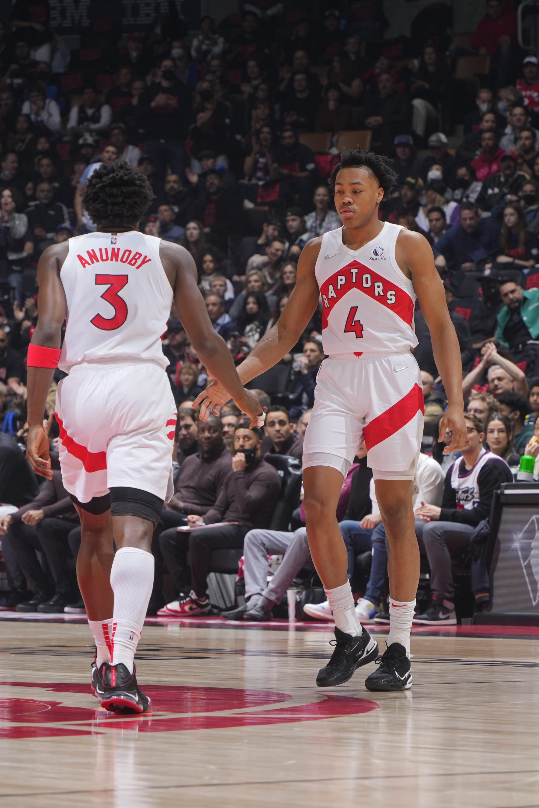 TORONTO, CANADA - APRIL 23:  OG Anunoby #3 and Scottie Barnes #4 of the Toronto Raptors high five during Round 1 Game 4 of the 2022 NBA Playoffs against the Philadelphia 76ers on April 23, 2022 at the Scotiabank Arena in Toronto, Ontario, Canada.  NOTE TO USER: User expressly acknowledges and agrees that, by downloading and or using this Photograph, user is consenting to the terms and conditions of the Getty Images License Agreement.  Mandatory Copyright Notice: Copyright 2022 NBAE (Photo by Mark Blinch/NBAE via Getty Images)