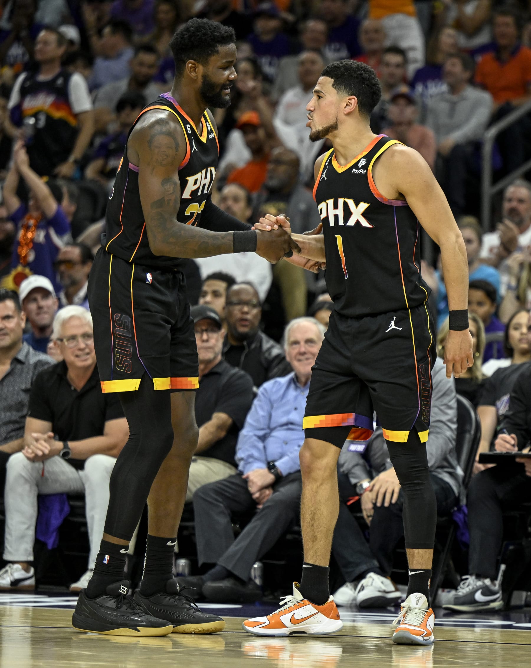 PHOENIX, AZ - MAY 5: Devin Booker (1) of the Phoenix Suns celebrates with Deandre Ayton (22) after drawing an offensive foul from Nikola Jokic (15) of the Denver Nuggets during the second quarter at Footprint Center in Phoenix on Friday, May 5, 2023. (Photo by AAron Ontiveroz/MediaNews Group/The Denver Post via Getty Images)