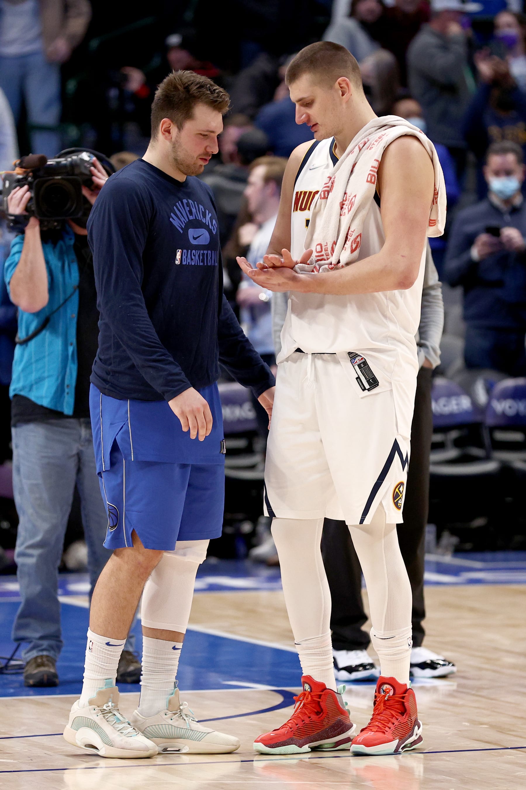 DALLAS, TEXAS - JANUARY 03: Luka Doncic #77 of the Dallas Mavericks talks with Nikola Jokic #15 of the Denver Nuggets after the Dallas Mavericks beat the Denver Nuggets 103-89 at American Airlines Center on January 03, 2022 in Dallas, Texas. NOTE TO USER: User expressly acknowledges and agrees that, by downloading and or using this photograph, User is consenting to the terms and conditions of the Getty Images License Agreement. (Photo by Tom Pennington/Getty Images)