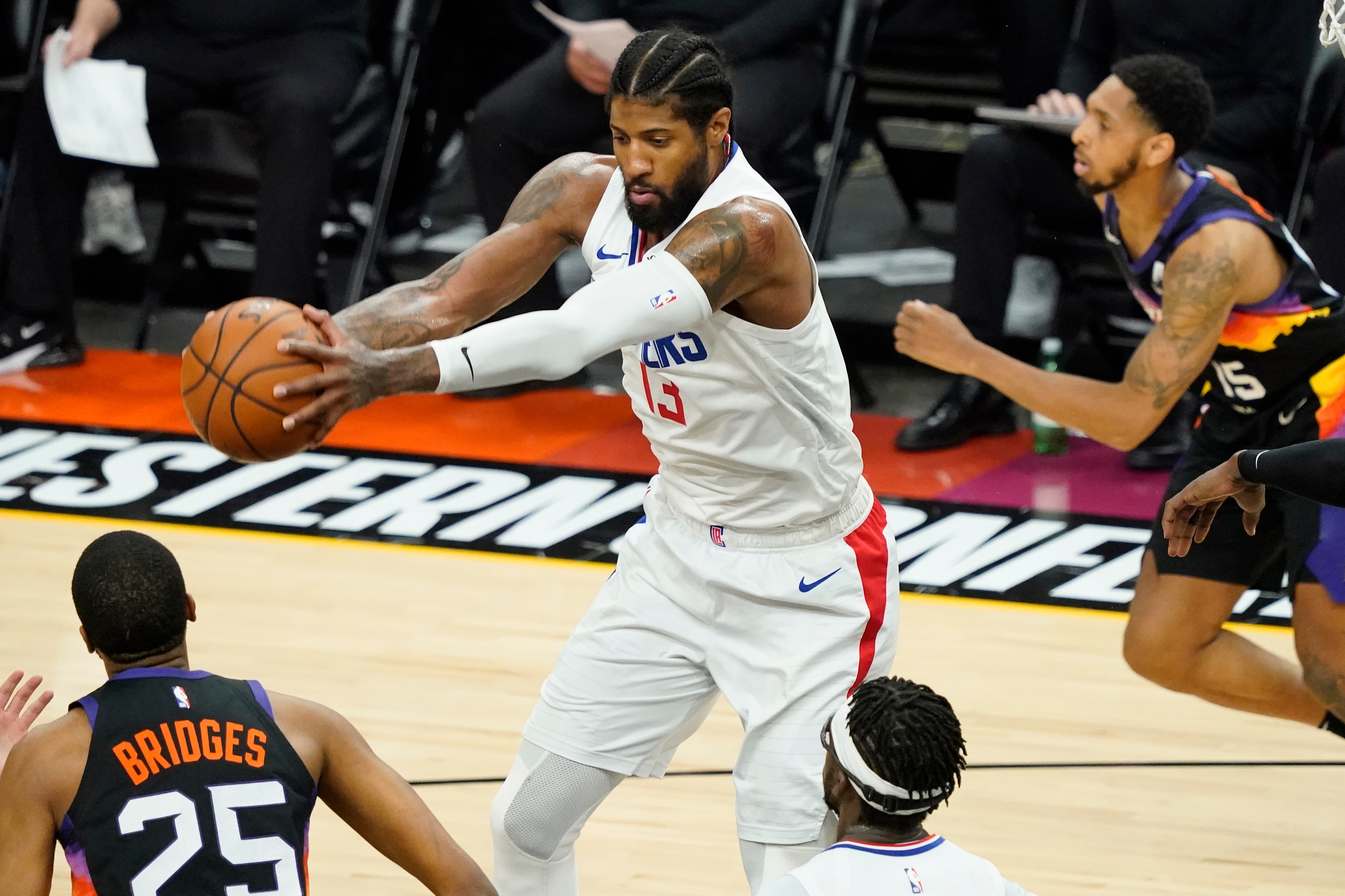Los Angeles Clippers guard Paul George (13) rebounds during the first half of game 5 of the NBA basketball Western Conference Finals against the Phoenix Suns, Monday, June 28, 2021, in Phoenix. (AP Photo/Matt York)