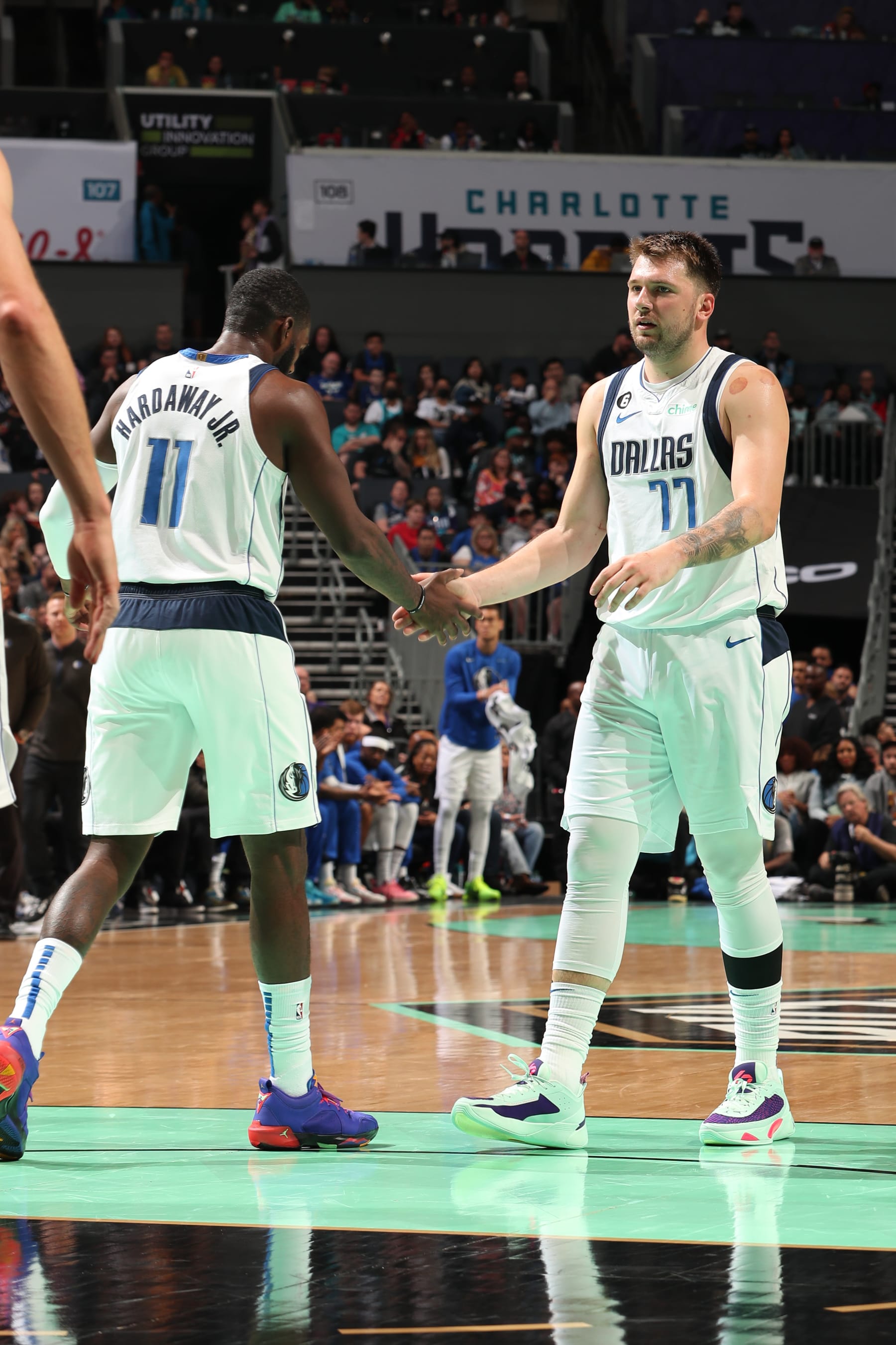 CHARLOTTE, NC - MARCH 26: Tim Hardaway Jr. #11 and Luka Doncic #77 of the Dallas Mavericks high five during the game against the Charlotte Hornets on March 26, 2023 at Spectrum Center in Charlotte, North Carolina. NOTE TO USER: User expressly acknowledges and agrees that, by downloading and or using this photograph, User is consenting to the terms and conditions of the Getty Images License Agreement. Mandatory Copyright Notice: Copyright 2023 NBAE (Photo by Kent Smith/NBAE via Getty Images)