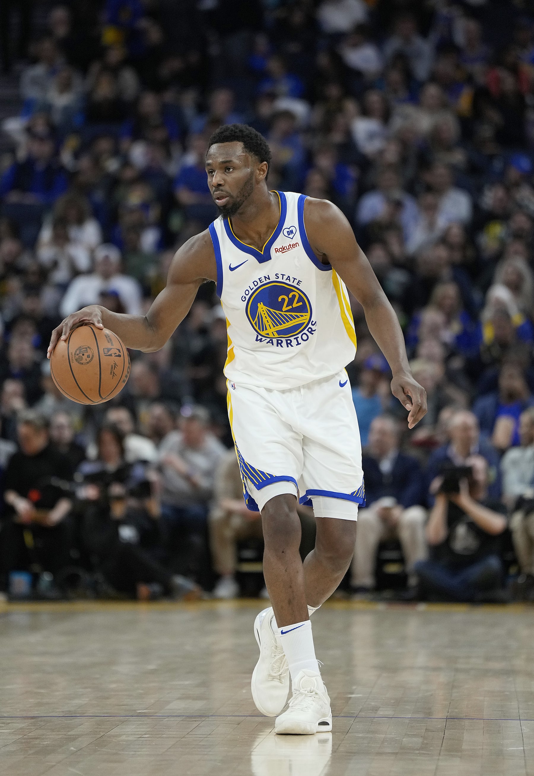 SAN FRANCISCO, CALIFORNIA - JANUARY 30: Andrew Wiggins #22 of the Golden State Warriors dribbles the ball up court against the Philadelphia 76ers during the third quarter of an NBA basketball game at Chase Center on January 30, 2024 in San Francisco, California. NOTE TO USER: User expressly acknowledges and agrees that, by downloading and or using this photograph, User is consenting to the terms and conditions of the Getty Images License Agreement. (Photo by Thearon W. Henderson/Getty Images)