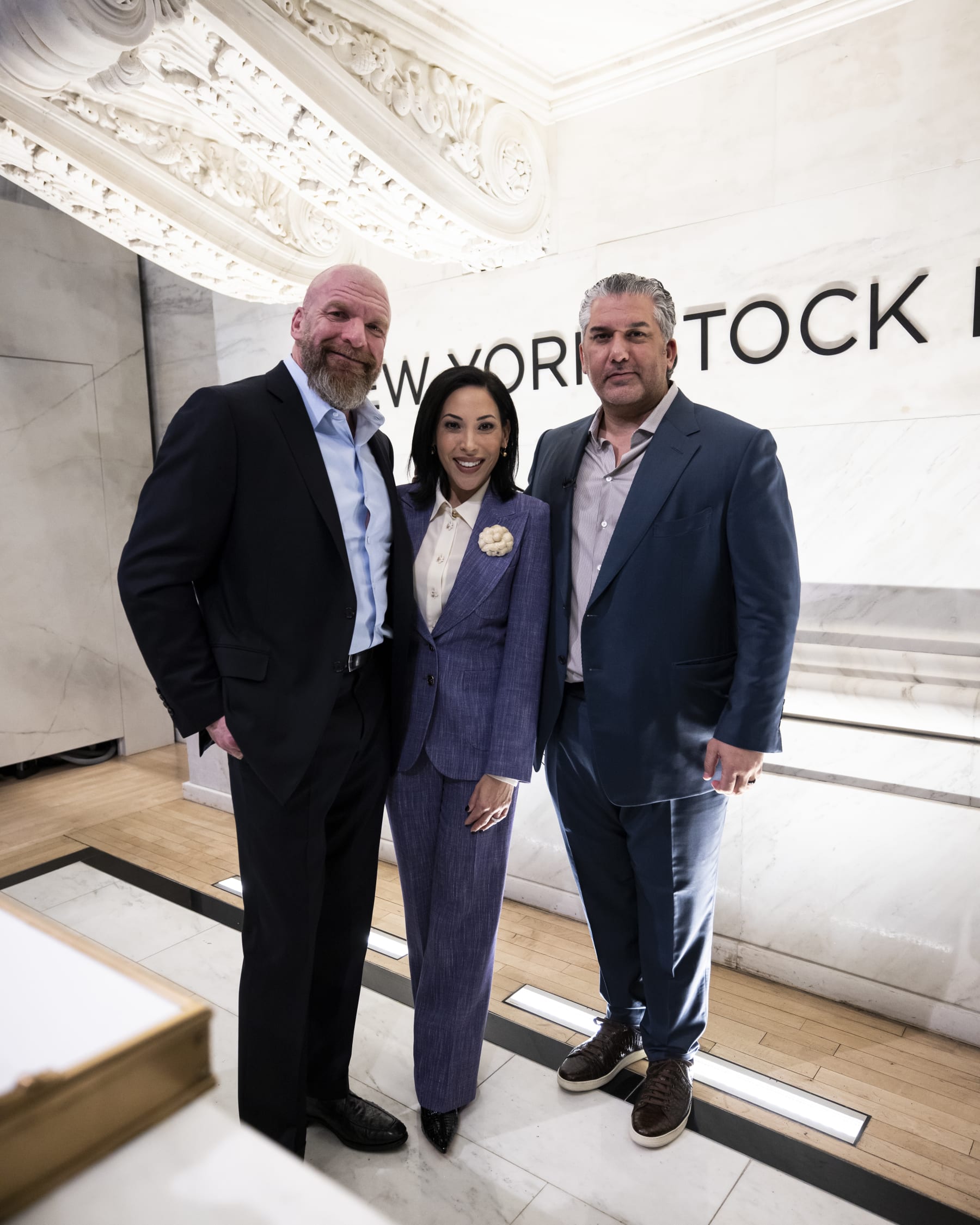 NEW YORK, NEW YORK - JANUARY 23: (L-R)  WWE Chief Content Officer Paul Levesque, TKO Board Director Sonya Medina Williams, and WWE President Nick Khan pose for a photo during a ceremony announcing Dwayne "The Rock" Johnson has joined the Board of Directors for TKO at New York Stock Exchange on January 23, 2024 in New York City. (Photo by Michelle Farsi/Zuffa LLC)