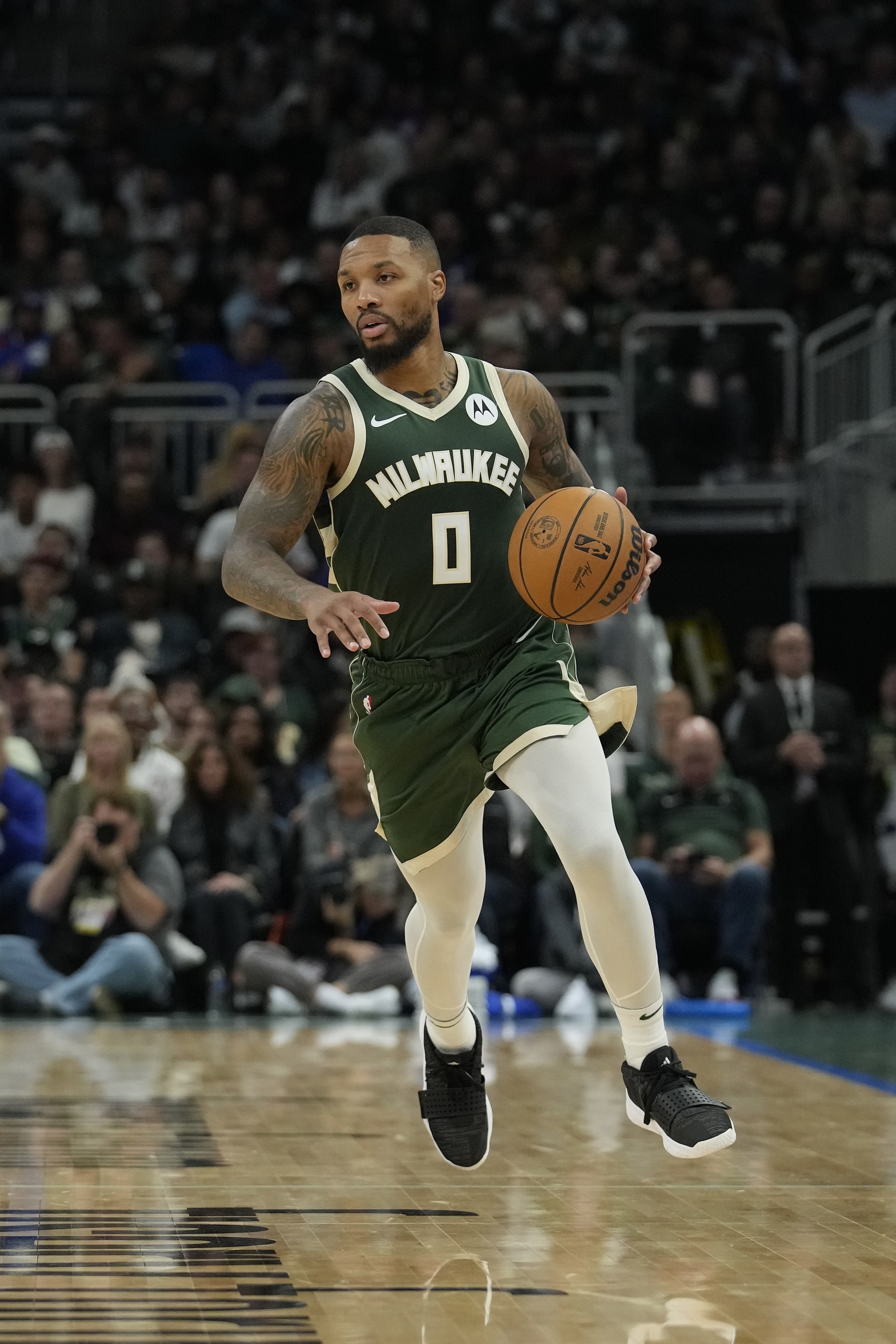 MILWAUKEE, WISCONSIN - OCTOBER 26: Damian Lillard #0 of the Milwaukee Bucks dribbles the ball against the Philadelphia 76ers in the first half at Fiserv Forum on October 26, 2023 in Milwaukee, Wisconsin. NOTE TO USER: User expressly acknowledges and agrees that, by downloading and or using this photograph, User is consenting to the terms and conditions of the Getty Images License Agreement. (Photo by Patrick McDermott/Getty Images)