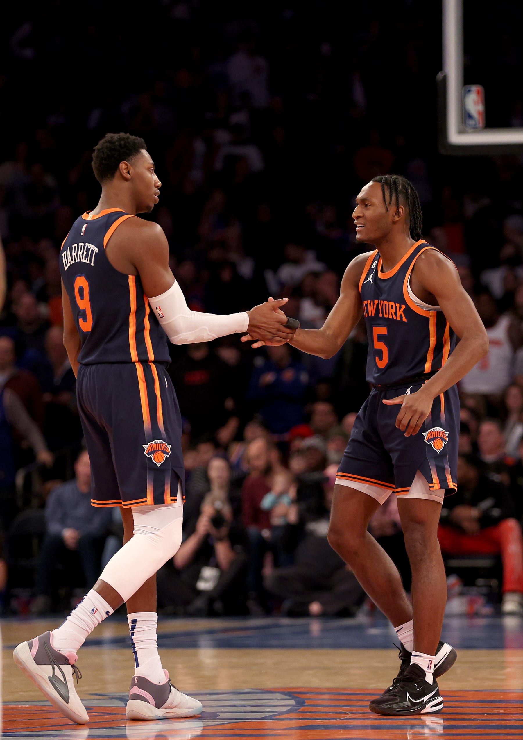 NEW YORK, NEW YORK - JANUARY 16: RJ Barrett #9 and Immanuel Quickley #5 of the New York Knicks celebrate a point during the second half at Madison Square Garden on January 16, 2023 in New York City. The Toronto Raptors defeated the New York Knicks 123-121 in overtime. NOTE TO USER: User expressly acknowledges and agrees that, by downloading and or using this photograph, User is consenting to the terms and conditions of the Getty Images License Agreement. (Photo by Elsa/Getty Images)