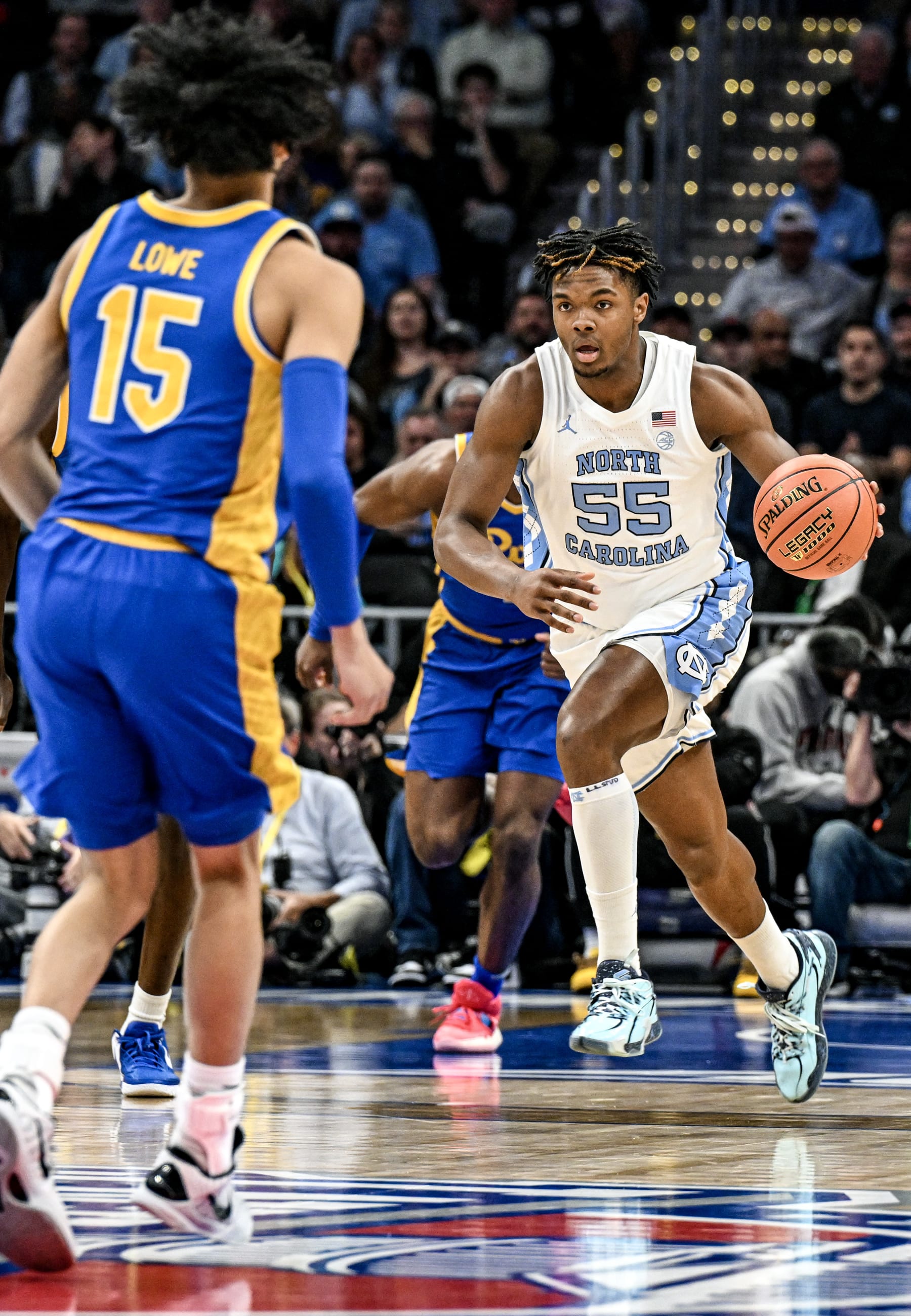 WASHINGTON, DC - MARCH 15: North Carolina Tar Heels forward Harrison Ingram (55) brings the ball up court against Pittsburgh Panthers guard Jaland Lowe (15) in the first game of the ACC Tournament Semi Final on March 15, 2024 at the Capital One Arena in Washington, D.C.  (Photo by Mark Goldman/Icon Sportswire via Getty Images)