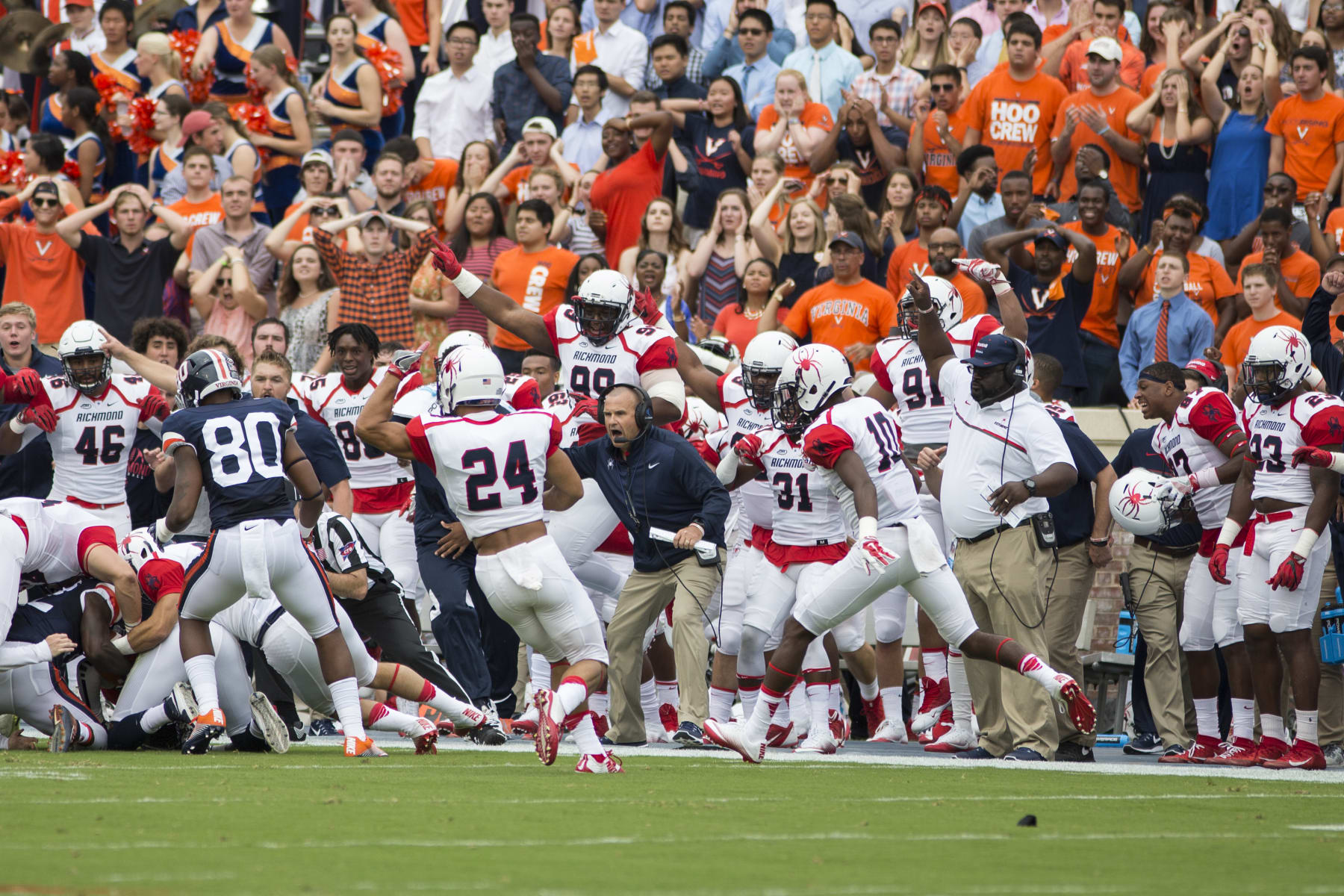 The Richmond Spiders bench cheers after a turnover against the Virginia Cavaliers