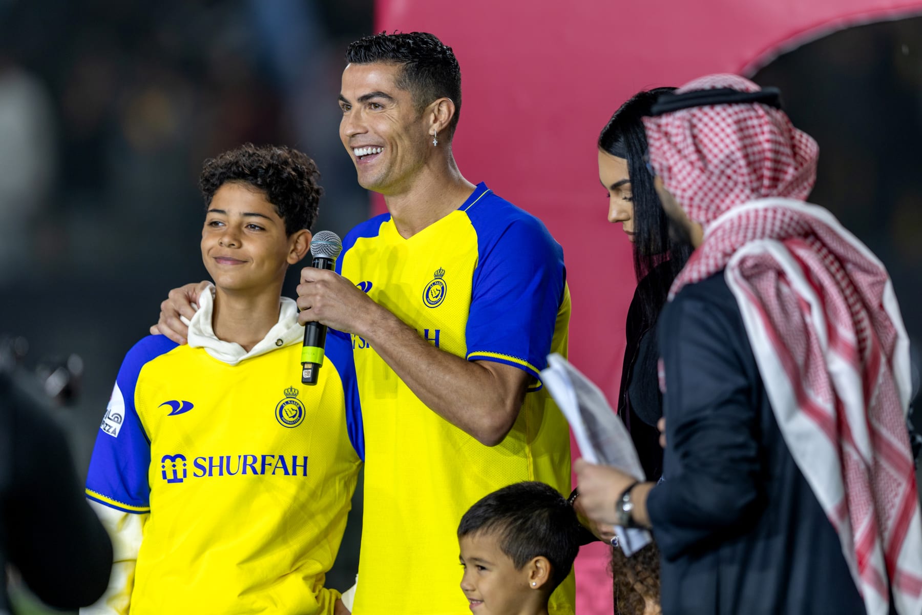 RIYADH, SAUDI ARABIA - JANUARY 03: Cristiano Ronaldo accompanied by his partner Georgina Rodriguez and his son Cristiano Ronaldo Jr, greet the crowd during the official unveiling of Cristiano Ronaldo as an Al Nassr player at Mrsool Park Stadium on January 3, 2023 in Riyadh, Saudi Arabia. (Photo by Yasser Bakhsh/Getty Images)