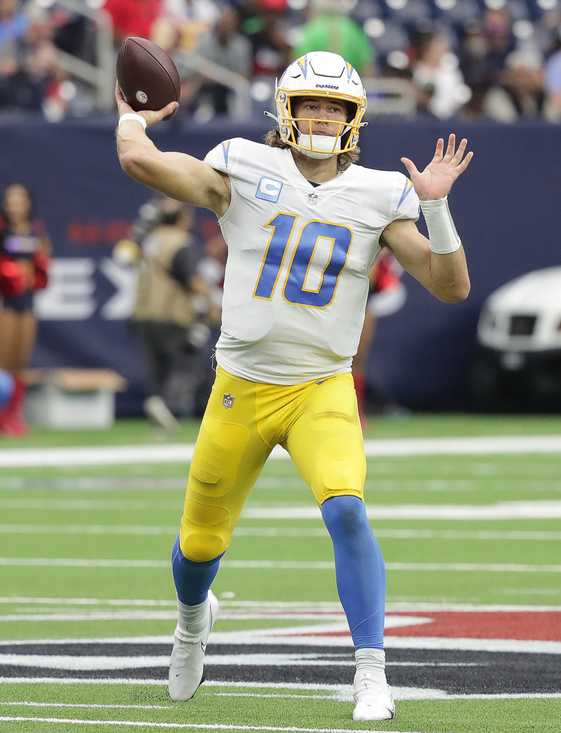 HOUSTON, TEXAS - DECEMBER 26: Justin Herbert #10 of the Los Angeles Chargers throws a pass against the Houston Texans at NRG Stadium on December 26, 2021 in Houston, Texas. (Photo by Bob Levey/Getty Images)