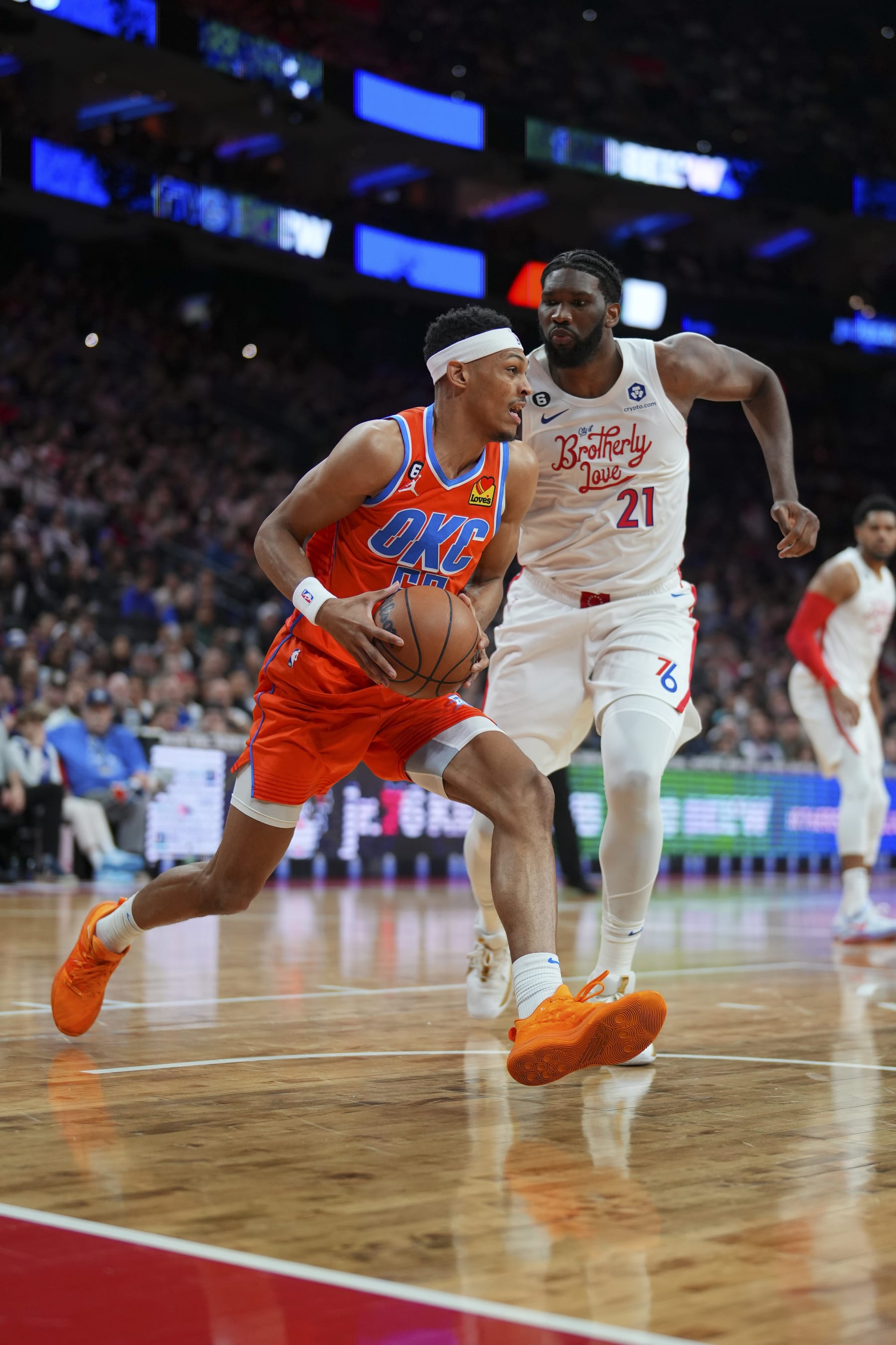 PHILADELPHIA, PA - JANUARY 12: Darius Bazley #55 of the Oklahoma City Thunder controls the ball against Joel Embiid #21 of the Philadelphia 76ers at the Wells Fargo Center on January 12, 2023 in Philadelphia, Pennsylvania. NOTE TO USER: User expressly acknowledges and agrees that, by downloading and or using this photograph, User is consenting to the terms and conditions of the Getty Images License Agreement. (Photo by Mitchell Leff/Getty Images)