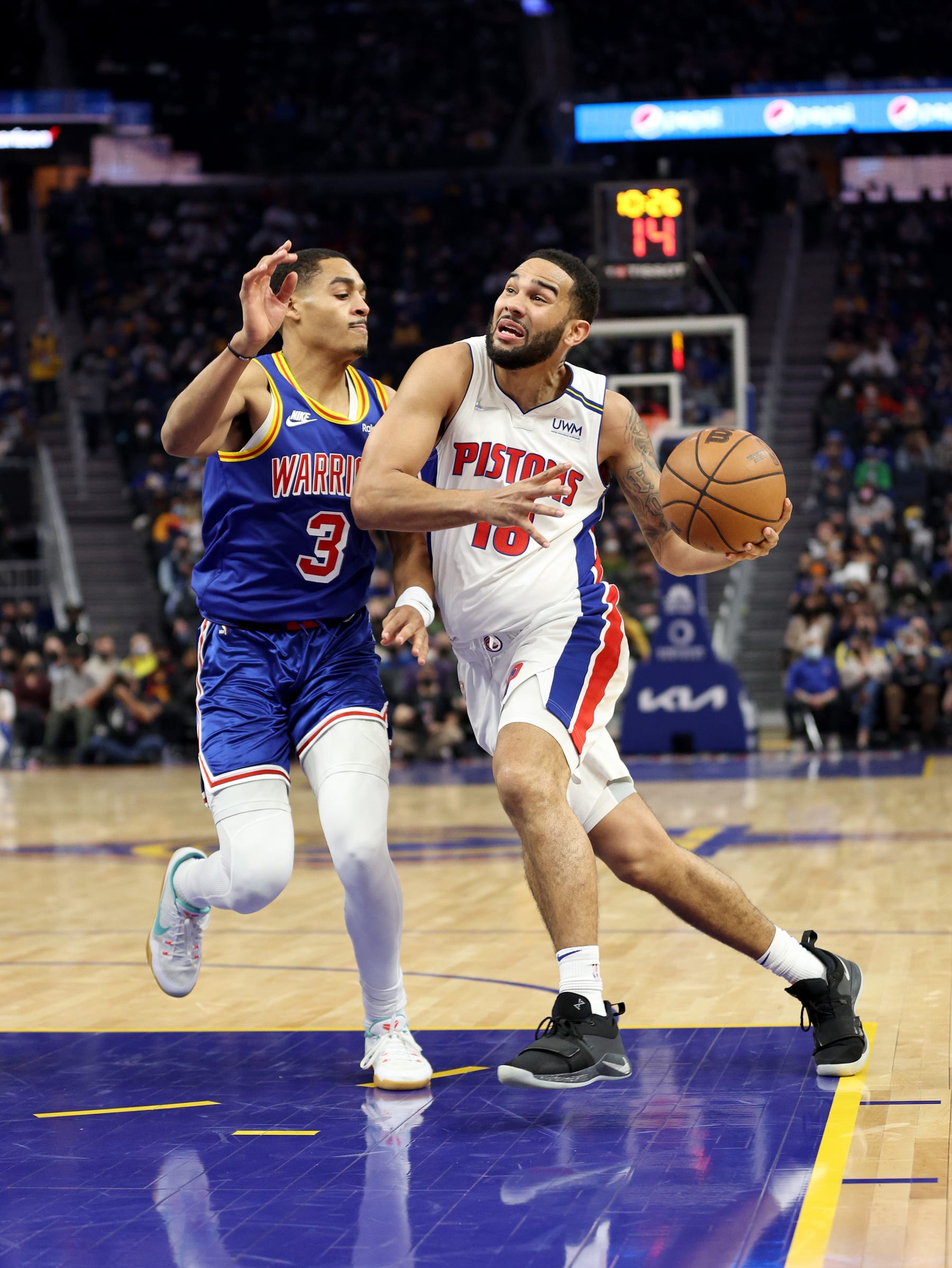 SAN FRANCISCO, CALIFORNIA - JANUARY 18:  Cory Joseph #18 of the Detroit Pistons is guarded by Jordan Poole #3 of the Golden State Warriors in the first half at Chase Center on January 18, 2022 in San Francisco, California. NOTE TO USER: User expressly acknowledges and agrees that, by downloading and/or using this photograph, User is consenting to the terms and conditions of the Getty Images License Agreement.  (Photo by Ezra Shaw/Getty Images)