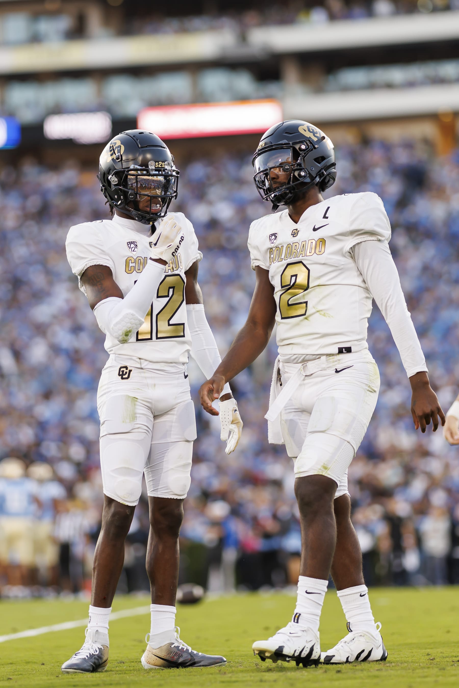 PASADENA, CALIFORNIA - OCTOBER 28: Travis Hunter #12 and Shedeur Sanders #2 of the Colorado Buffaloes on the sideline during the first half of a game against the UCLA Bruins at Rose Bowl Stadium on October 28, 2023 in Pasadena, California. (Photo by Ryan Kang/Getty Images)