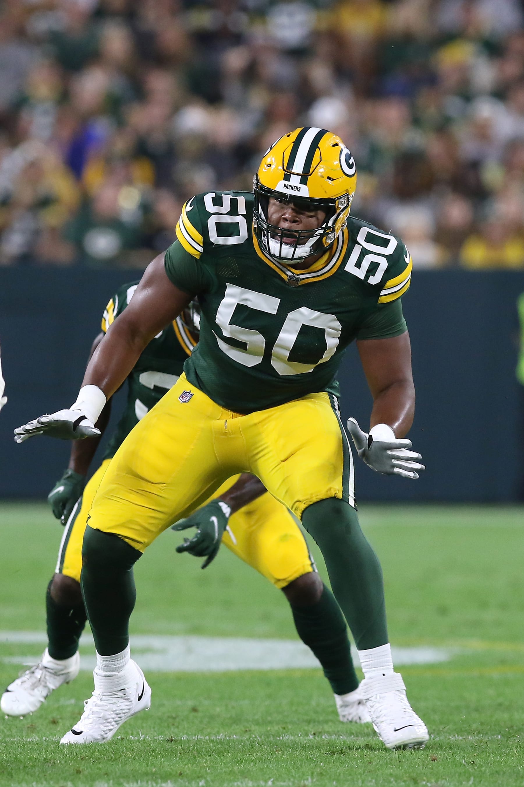GREEN BAY, WI - AUGUST 19: Green Bay Packers guard Zach Tom (50) drops back to block during an NFL preseason game between the Green Bay Packers and the New Orleans Saints on August 19, 2022, at Lambeau Field in Green Bay, WI. (Photo by Larry Radloff/Icon Sportswire via Getty Images)