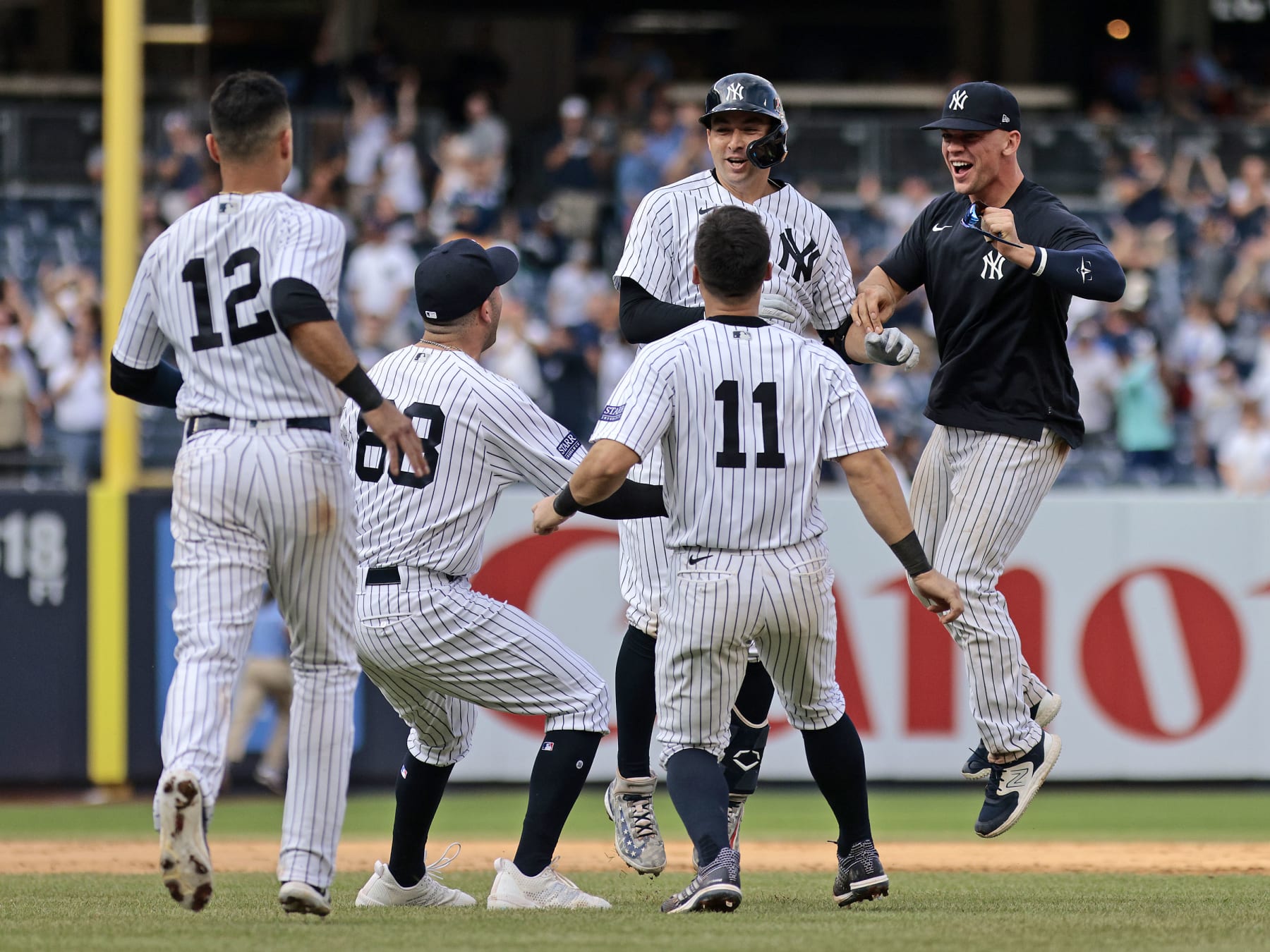 NEW YORK, NEW YORK - SEPTEMBER 10: Kyle Higashioka #66 of the New York Yankees is congratulated by his teammates after hitting a walk-off double to defeat the Milwaukee Brewers by 4-3 in the bottom of the thirteenth inning at Yankee Stadium on September 10, 2023 in the Bronx borough of New York City. (Photo by Christopher Pasatieri/Getty Images)