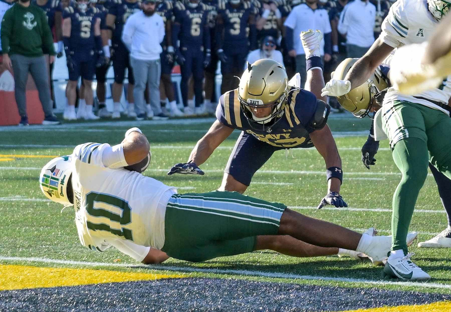 ANNAPOLIS, MD - NOVEMBER 16:  Tulane Green Wave quarterback Darian Mensah (10) is stopped short of the goal line by Navy Midshipmen cornerback Andrew Duhart (13) during the Tulane Green Wave game versus the Naval Academy Midshipmen on November 16, 2024 at Navy - Marine Corps Memorial Stadium in Annapolis, MD. (Photo by Mark Goldman/Icon Sportswire via Getty Images)