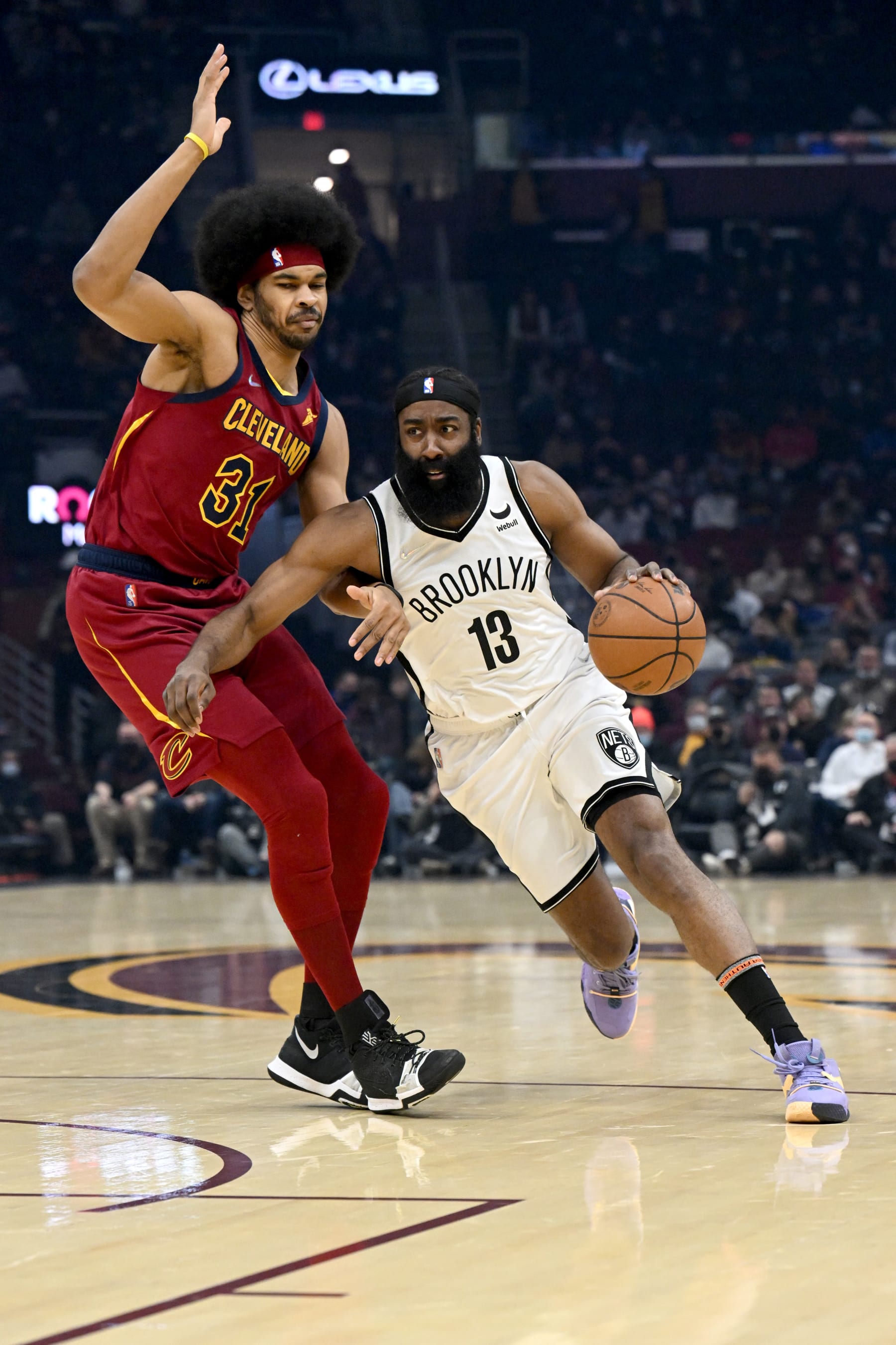 CLEVELAND, OHIO - JANUARY 17: James Harden #13 of the Brooklyn Nets drives to the basket around Jarrett Allen #31 of the Cleveland Cavaliers during the first quarter at Rocket Mortgage Fieldhouse on January 17, 2022 in Cleveland, Ohio. NOTE TO USER: User expressly acknowledges and agrees that, by downloading and/or using this photograph, user is consenting to the terms and conditions of the Getty Images License Agreement. (Photo by Jason Miller/Getty Images)