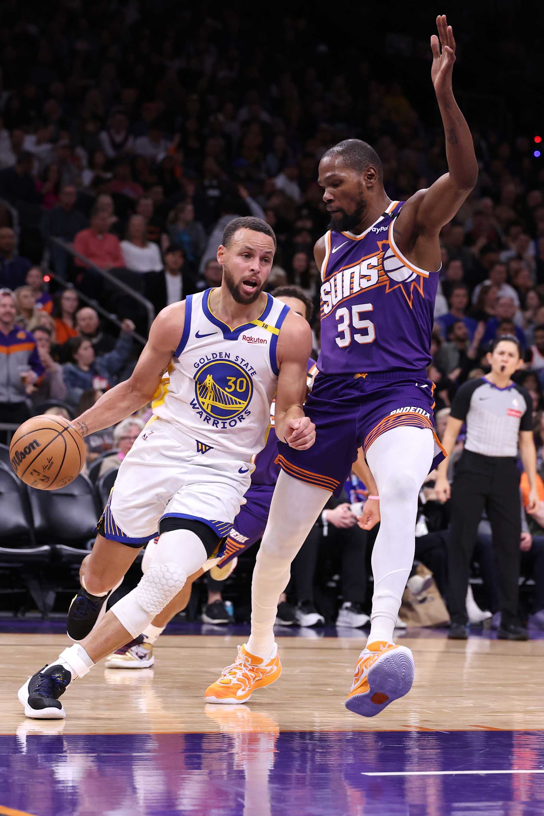PHOENIX, ARIZONA - NOVEMBER 30: Stephen Curry #30 of the Golden State Warriors drives on Kevin Durant #35 of the Phoenix Suns during the game at Footprint Center on November 30, 2024 in Phoenix, Arizona. The Suns defeated the Warriors 113-105. NOTE TO USER: User expressly acknowledges and agrees that, by downloading and or using this photograph, User is consenting to the terms and conditions of the Getty Images License Agreement.  (Photo by Chris Coduto/Getty Images)