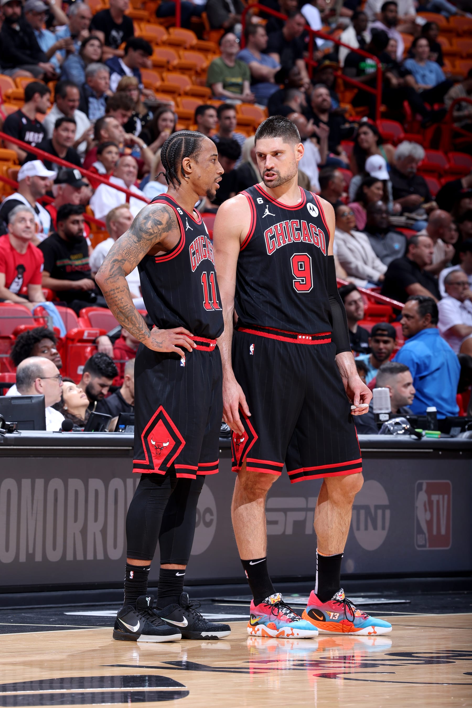 MIAMI, FL - APRIL 14: DeMar DeRozan #11 and Nikola Vucevic #9 of the Chicago Bulls talk on the court during the game against the Miami Heat  During the 2023 Play-in Tournament on April 14, 2023 at Kaseya Center in Miami, Florida. NOTE TO USER: User expressly acknowledges and agrees that, by downloading and or using this photograph, User is consenting to the terms and conditions of the Getty Images License Agreement. Mandatory Copyright Notice: Copyright 2023 NBAE (Photo by Jeff Haynes/NBAE via Getty Images)