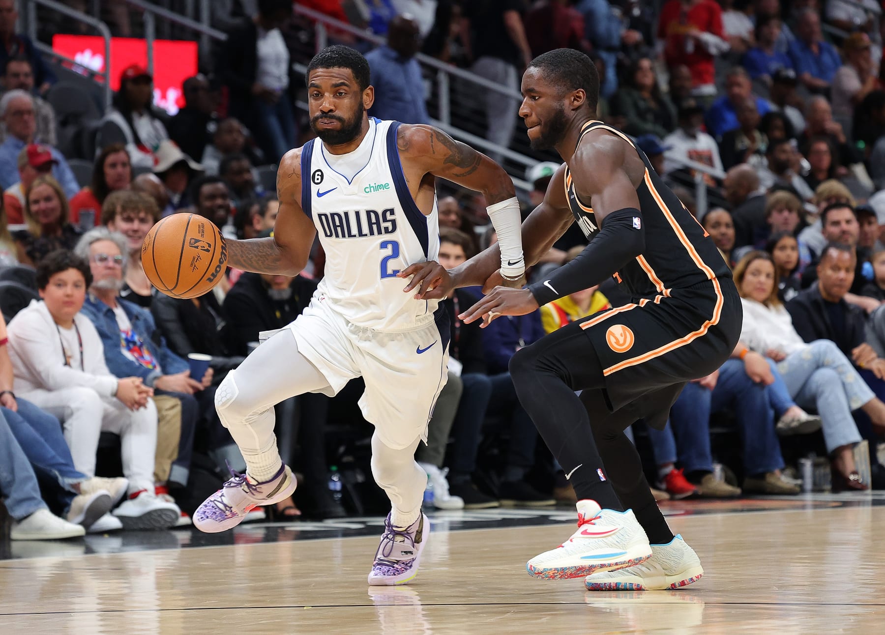 ATLANTA, GEORGIA - APRIL 02:  Kyrie Irving #2 of the Dallas Mavericks drives against AJ Griffin #14 of the Atlanta Hawks during the first quarter at State Farm Arena on April 02, 2023 in Atlanta, Georgia.  NOTE TO USER: User expressly acknowledges and agrees that, by downloading and or using this photograph, User is consenting to the terms and conditions of the Getty Images License Agreement.  (Photo by Kevin C. Cox/Getty Images)
