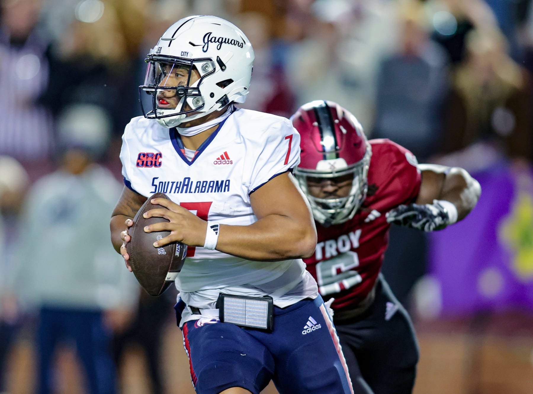 TROY, ALABAMA - NOVEMBER 2: Gio Lopez #7 of the South Alabama Jaguars looks downfield while evading the tackle of Javon Solomon #6 of the Troy Trojans during the first half against the Troy Trojans at Veterans Memorial Stadium on November 2, 2023 in Troy, Alabama. (Photo by Brandon Sumrall/Getty Images)