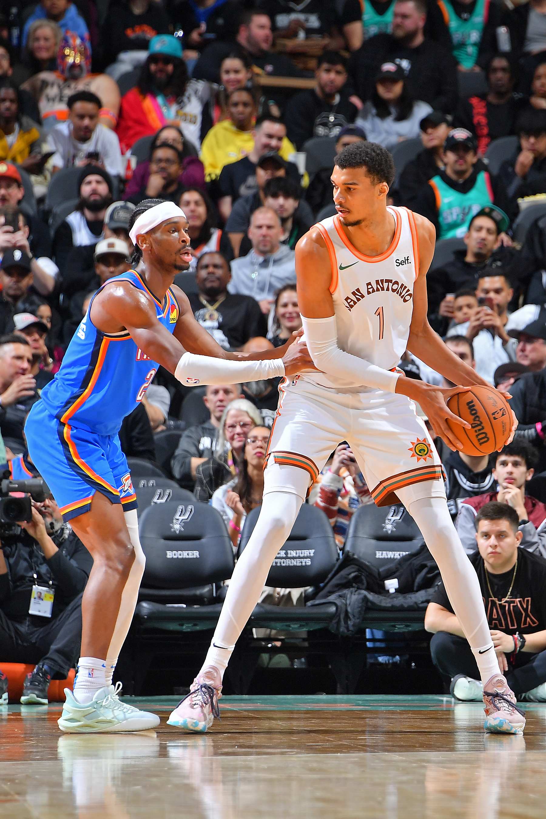 SAN ANTONIO, TX - JANUARY 24: Shai Gilgeous-Alexander #2 of the Oklahoma City Thunder plays defense against Victor Wembanyama #1 of the San Antonio Spurs during the game on January 24, 2024 at the Frost Bank Center in San Antonio, Texas. NOTE TO USER: User expressly acknowledges and agrees that, by downloading and or using this photograph, user is consenting to the terms and conditions of the Getty Images License Agreement. Mandatory Copyright Notice: Copyright 2024 NBAE (Photos by Michael Gonzales/NBAE via Getty Images)