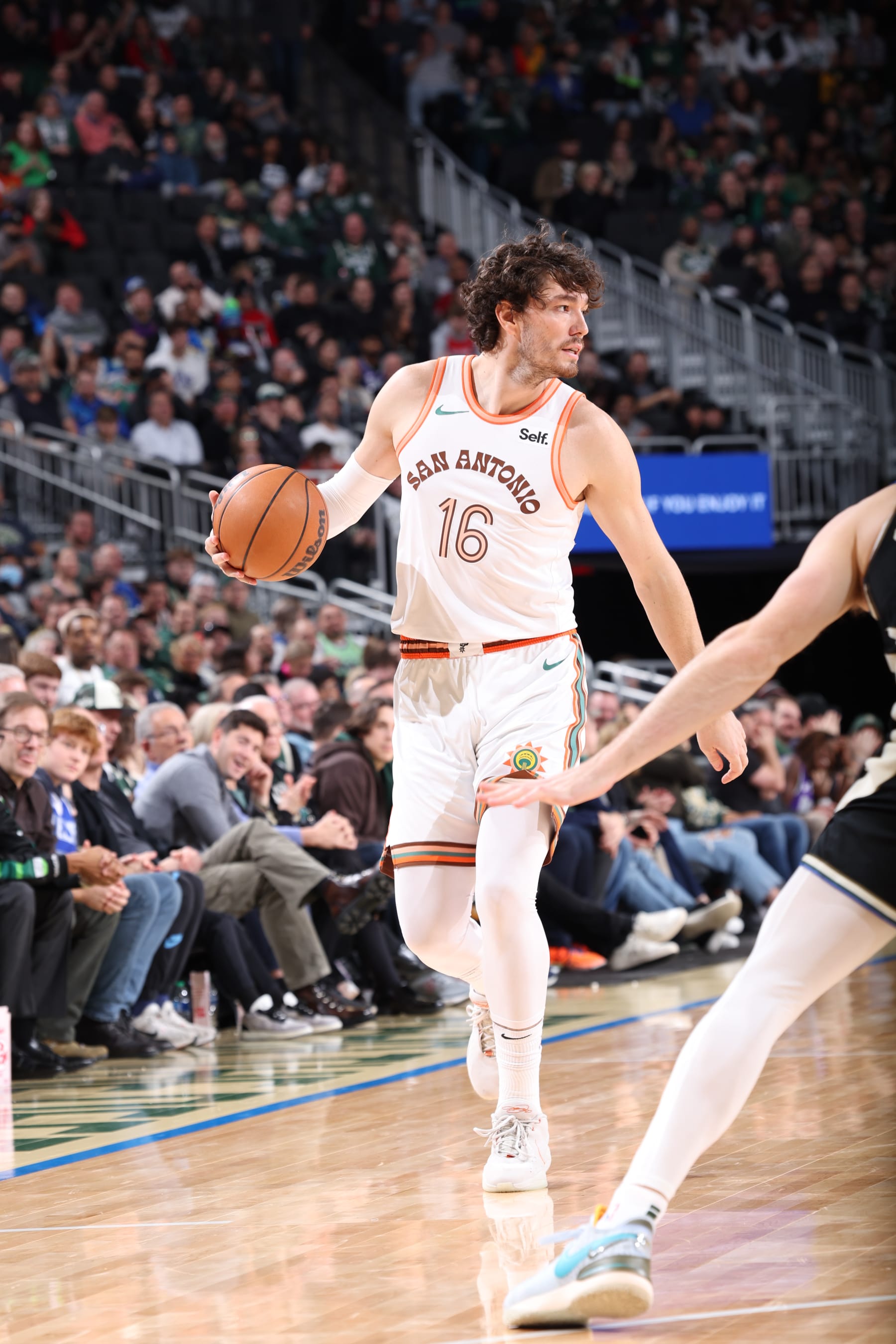MILWAUKEE, WI - DECEMBER 19: Cedi Osman #16 of the San Antonio Spurs handles the ball during the game against the Milwaukee Bucks on December 19, 2023 at the Fiserv Forum Center in Milwaukee, Wisconsin. NOTE TO USER: User expressly acknowledges and agrees that, by downloading and or using this Photograph, user is consenting to the terms and conditions of the Getty Images License Agreement. Mandatory Copyright Notice: Copyright 2023 NBAE (Photo by Gary Dineen/NBAE via Getty Images).