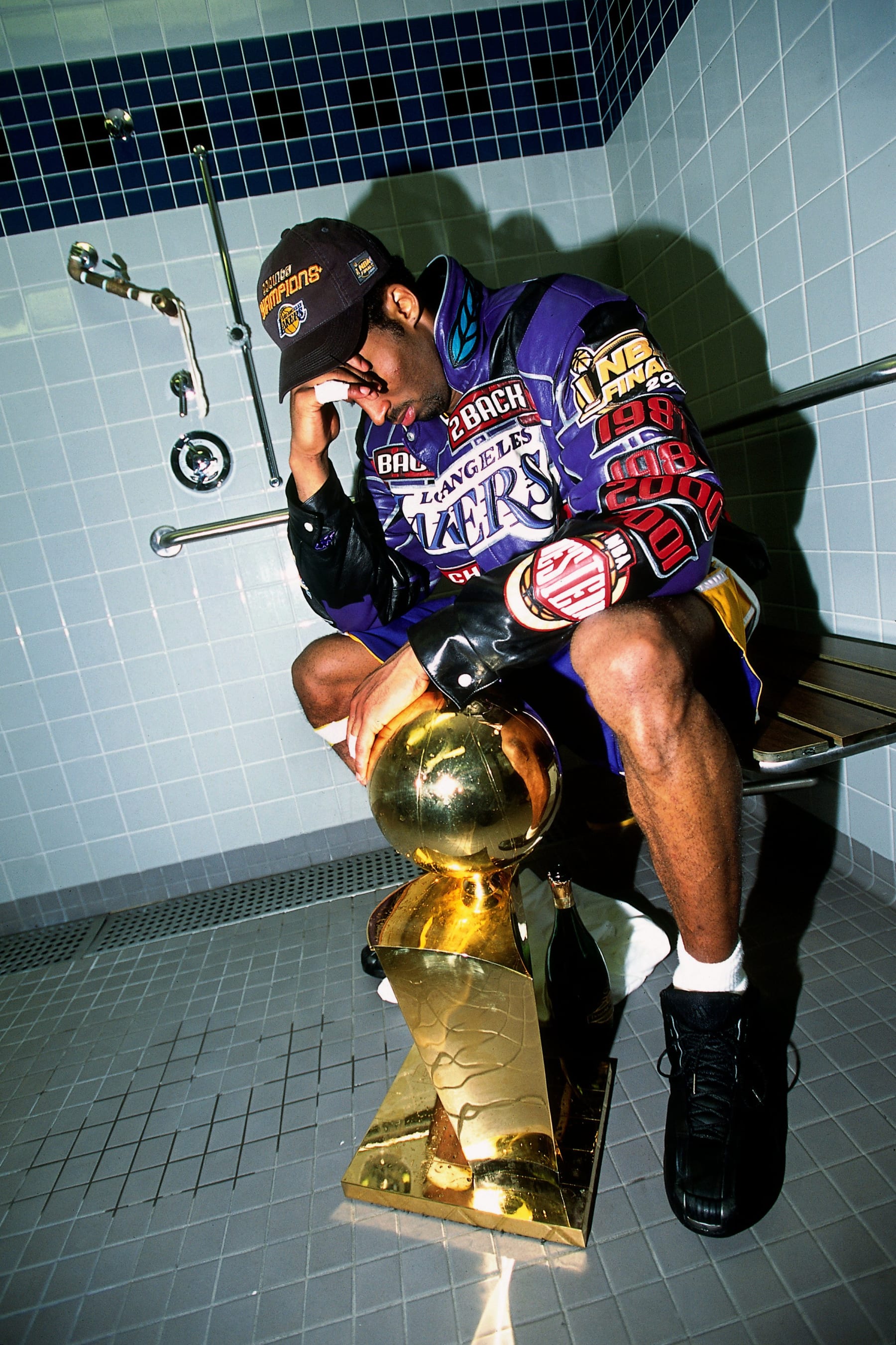 PHILADELPHIA - JUNE 15:  Kobe Bryant #8 poses with the NBA Championship trophy after defeating the Philadelphia 76ers in game five of the 2001 NBA Finals played June 15, 2001 at the First Union Center in Philadelphia, Pennsylvania.  NOTE TO USER: User expressly acknowledges that, by downloading and or using this photograph, User is consenting to the terms and conditions of the Getty Images License agreement. Mandatory Copyright Notice: Copyright 2001 NBAE (Photo by Andrew D. Bernstein/NBAE via Getty Images)