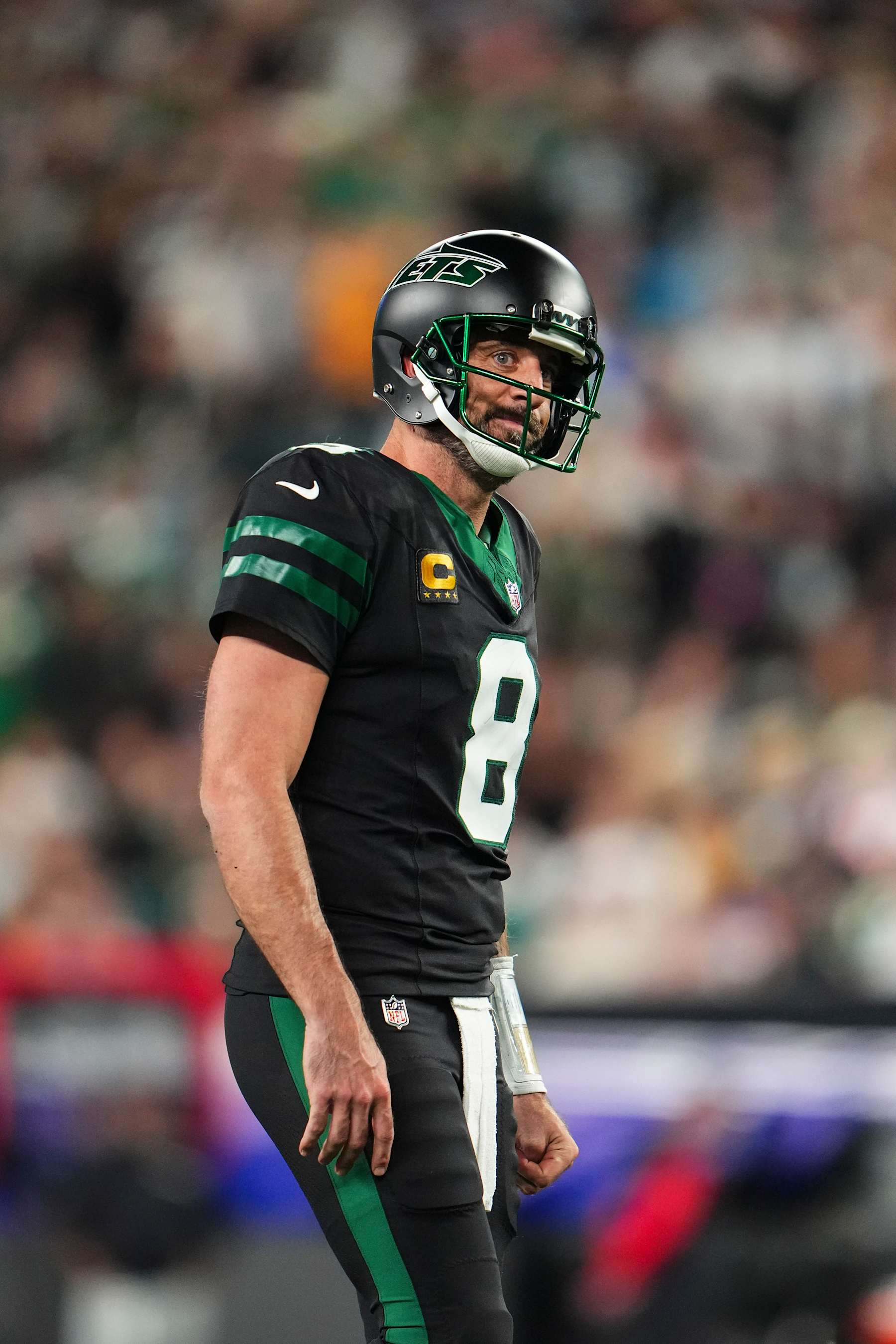 EAST RUTHERFORD, NJ - OCTOBER 31: Aaron Rodgers #8 of the New York Jets looks on from the field during an NFL football game against the Houston Texans at MetLife Stadium on October 31, 2024 in East Rutherford, New Jersey. (Photo by Cooper Neill/Getty Images)