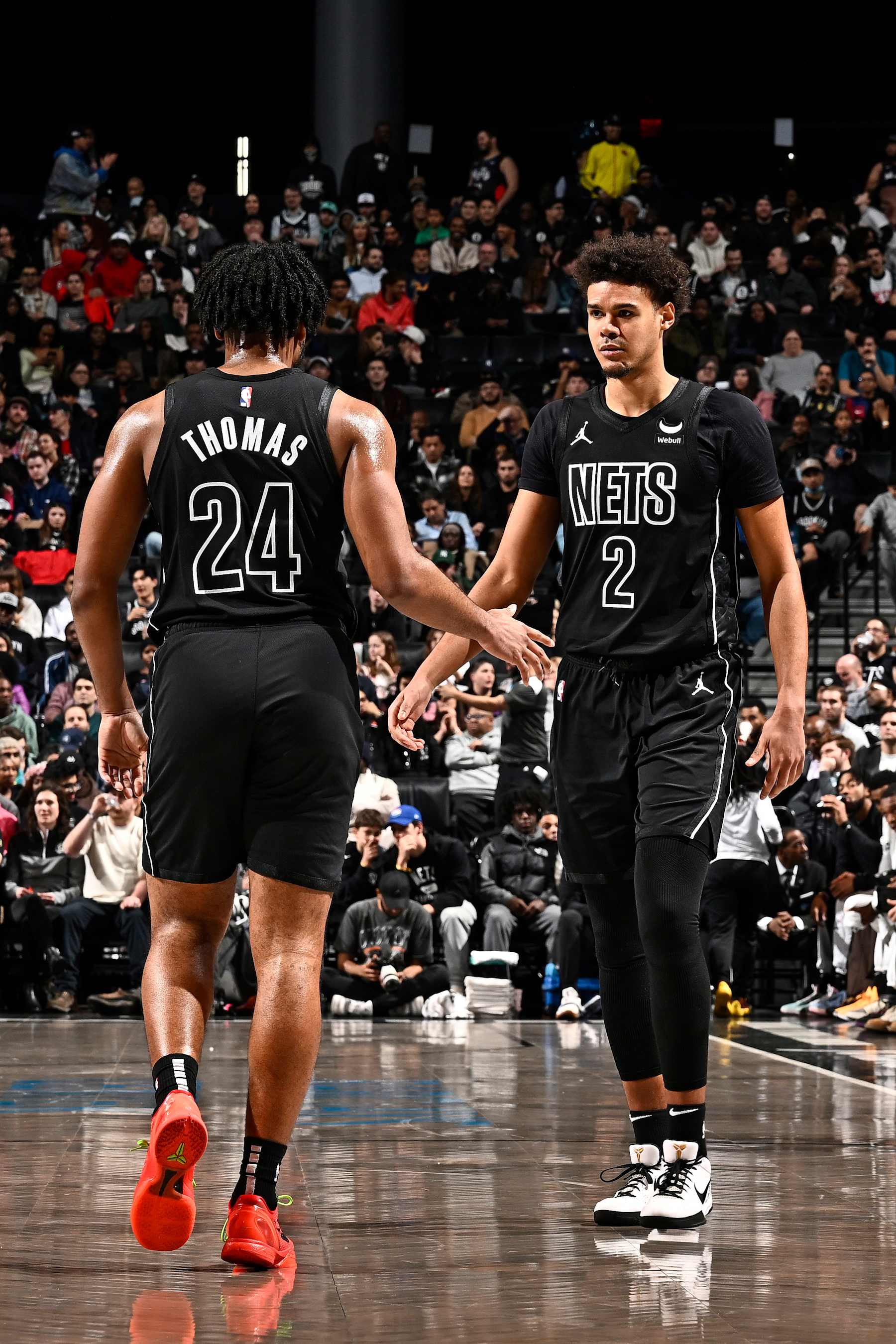 BROOKLYN, NY - JANUARY 25: Cam Thomas #24 and Cameron Johnson #2 of the Brooklyn Nets high five during the game against the Minnesota Timberwolves on January 25, 2024 at Barclays Center in Brooklyn, New York. NOTE TO USER: User expressly acknowledges and agrees that, by downloading and or using this Photograph, user is consenting to the terms and conditions of the Getty Images License Agreement. Mandatory Copyright Notice: Copyright 2024 NBAE (Photo by David Dow/NBAE via Getty Images)