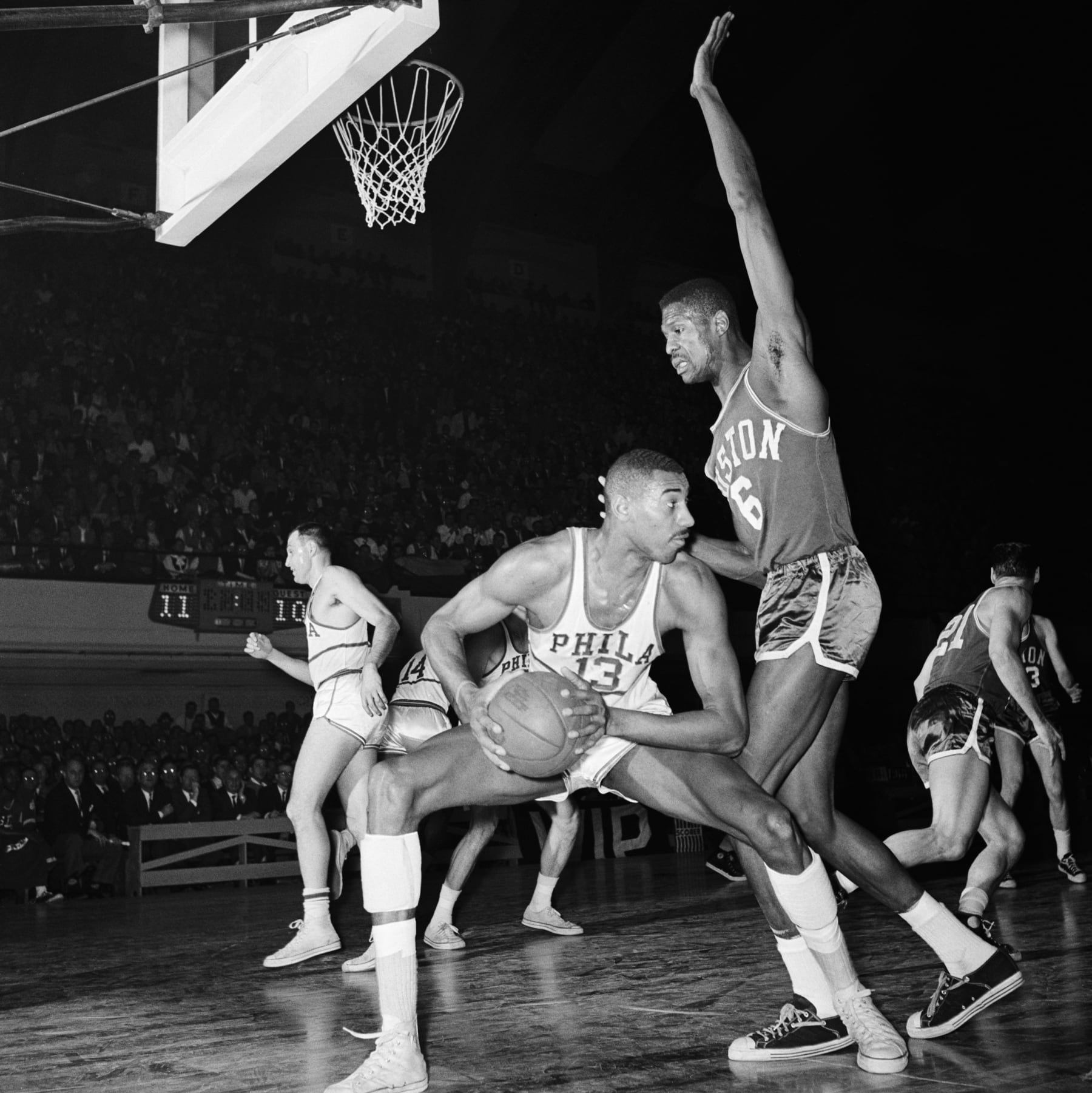 Boston Celtic Bill Russell blocks a pass or shot by Wilt Chamberlain of the Philadelphia Warriors.