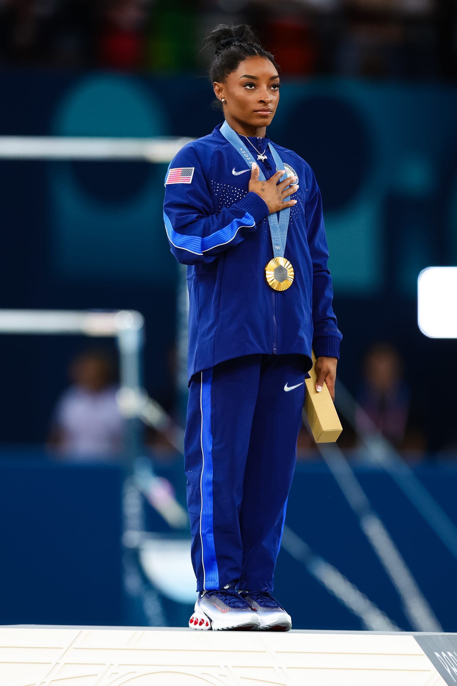 PARIS, FRANCE - AUGUST 01: Simone Biles of USA during the USA National Anthem after winning Gold at the Artistic Gymnastics WomenÕs All-Round Final at the Paris 2024 Olympic Games at the Bercy Arena on August 01, 2024 in Paris, France. (Photo by Pete Dovgan/Speed Media/Icon Sportswire via Getty Images)