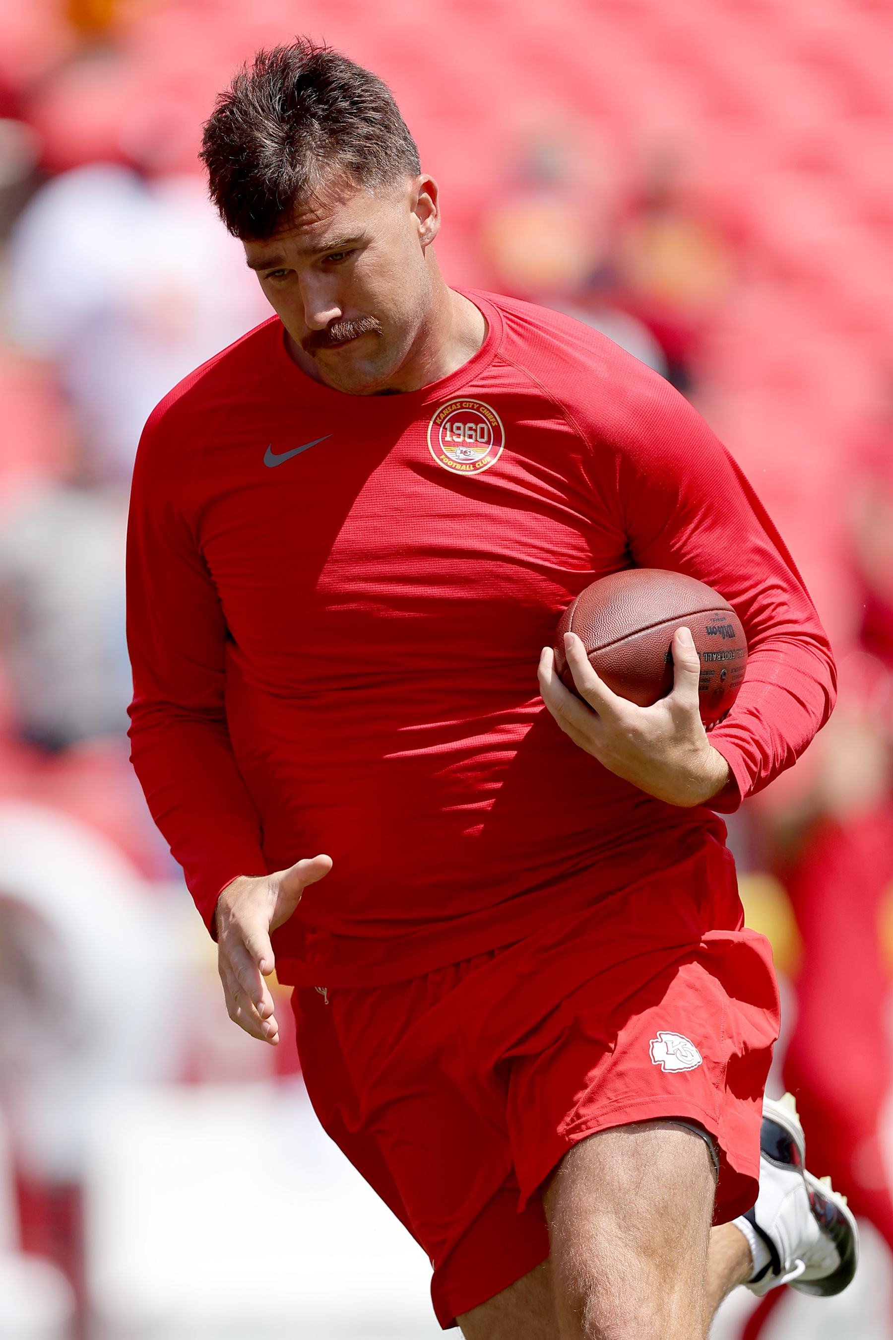 KANSAS CITY, MISSOURI - AUGUST 17: Travis Kelce #87 of the Kansas City Chiefs runs during pregame warmups prior to a preseason game against the Detroit Lions at GEHA Field at Arrowhead Stadium on August 17, 2024 in Kansas City, Missouri. (Photo by David Eulitt/Getty Images)