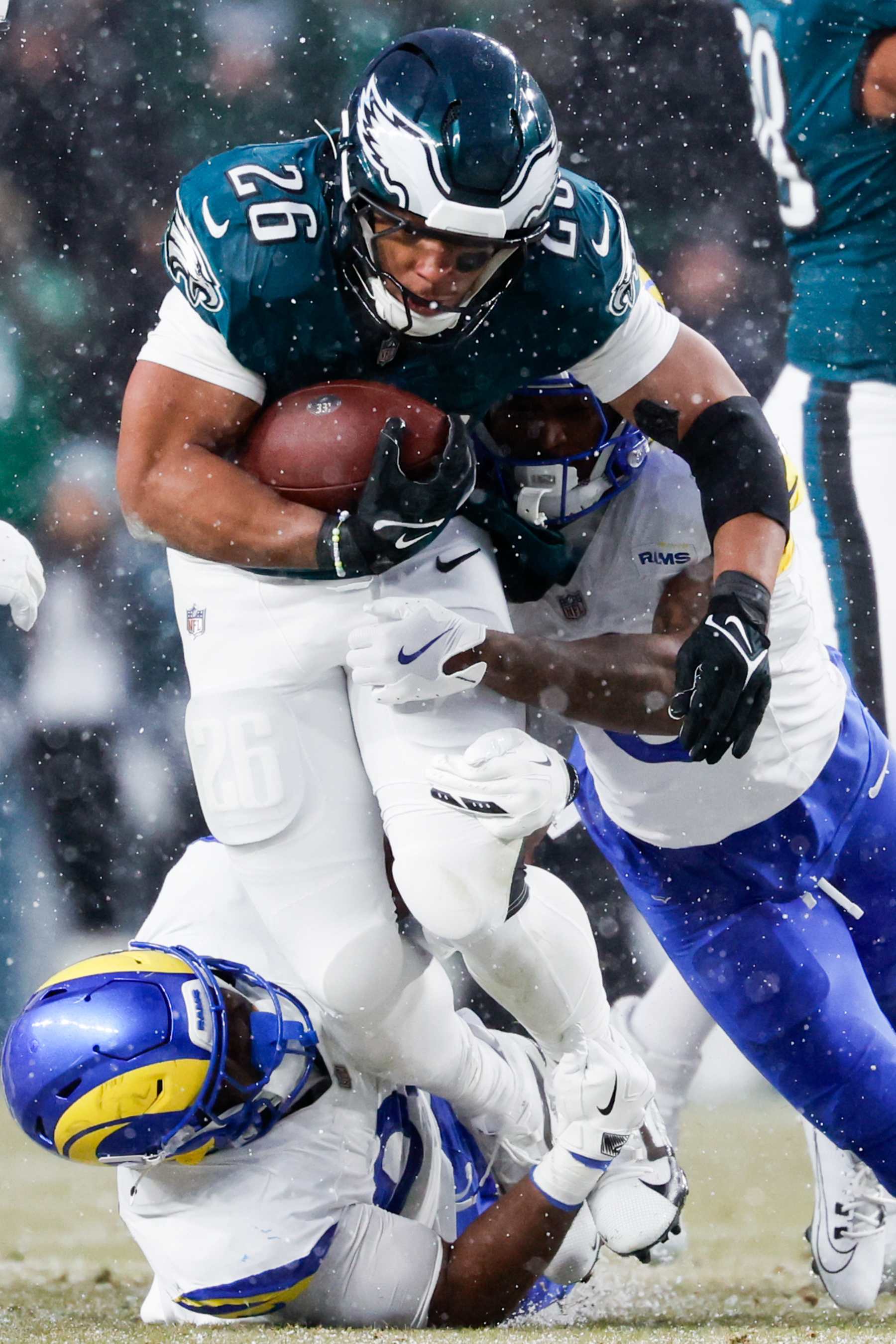 PHILADELPHIA, PA - JANUARY 19: Philadelphia Eagles running back Saquon Barkley, top, pushes through the Los Angeles Rams defense during the second quarter during an NFC divisional round at Lincoln Financial Field on Sunday, Jan. 19, 2025 in Philadelphia, PA. (Gina Ferazzi / Los Angeles Times via Getty Images)