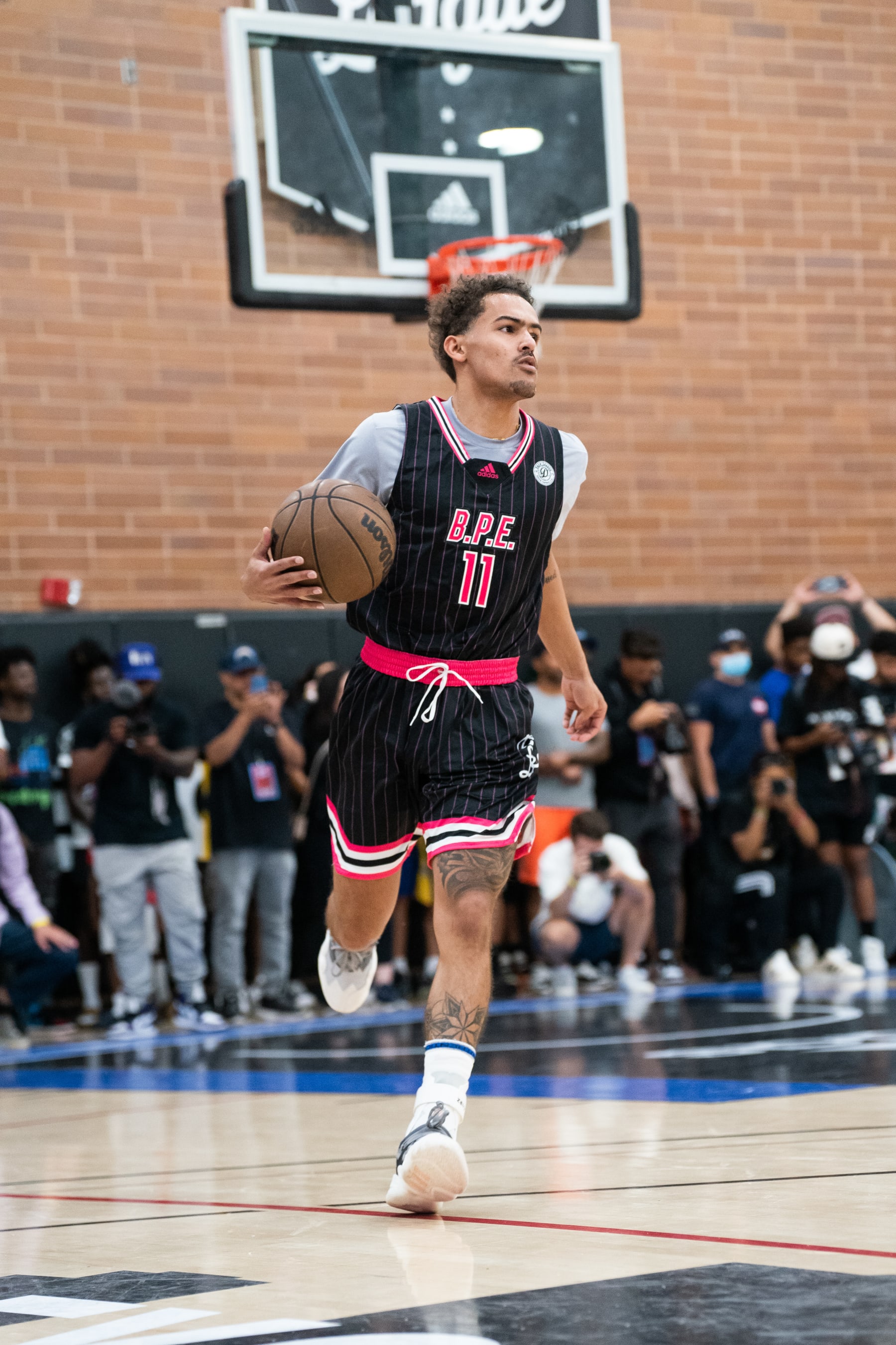 LOS ANGELES, CALIFORNIA - JULY 23: Trae Young dribbles the ball in his game during the Drew League Pro-Am at King Drew Magnet High School on July 23, 2022 in Los Angeles, California. (Photo by Cassy Athena/Getty Images)