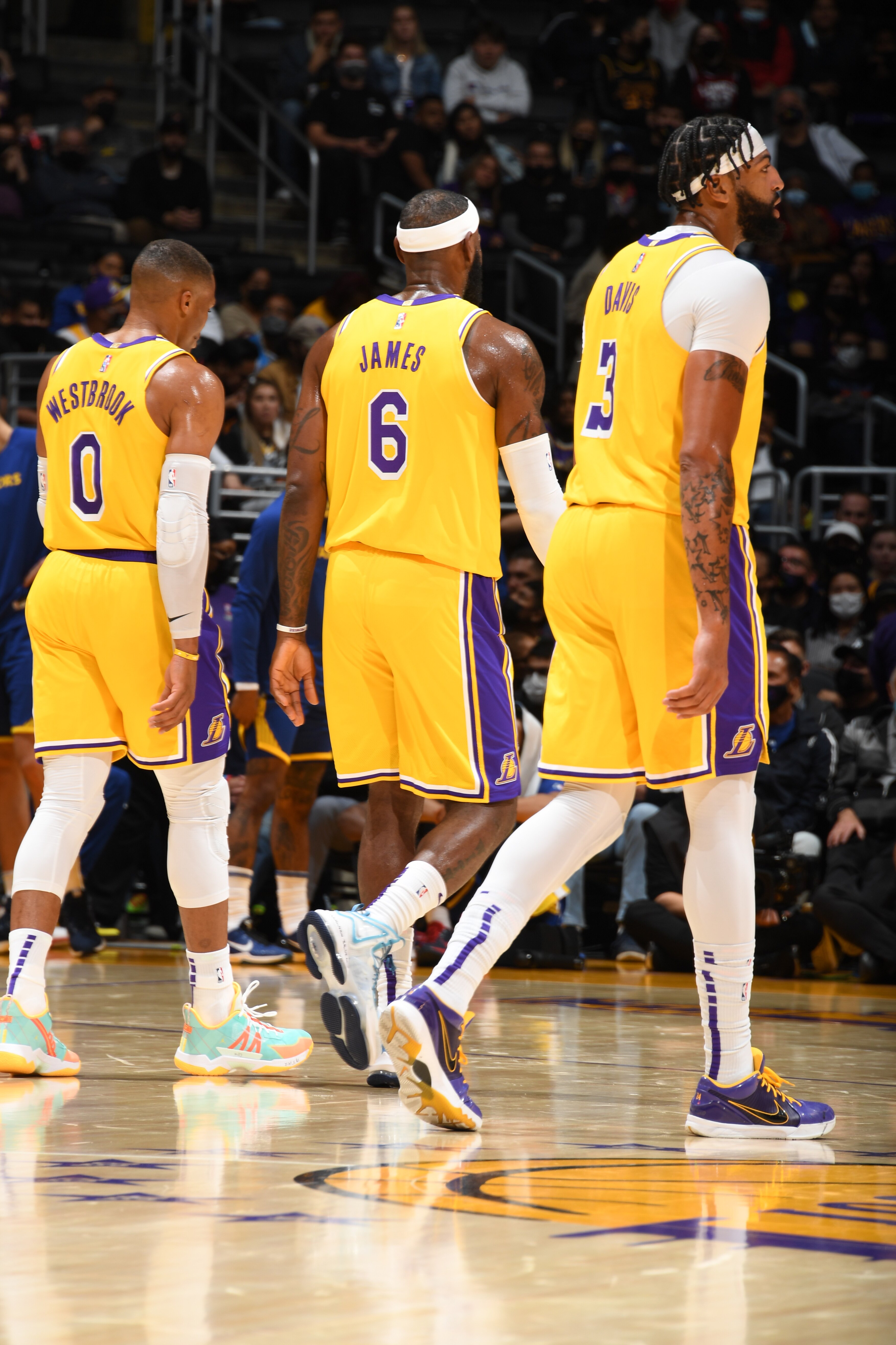 LOS ANGELES, CA - OCTOBER 12: Russell Westbrook #0, LeBron James #6 and Anthony Davis #3 of the Los Angeles Lakers look on during a preseason game against the Golden State Warriors on October 12, 2021 at STAPLES Center in Los Angeles, California. NOTE TO USER: User expressly acknowledges and agrees that, by downloading and/or using this Photograph, user is consenting to the terms and conditions of the Getty Images License Agreement. Mandatory Copyright Notice: Copyright 2021 NBAE (Photo by Andrew D. Bernstein/NBAE via Getty Images)